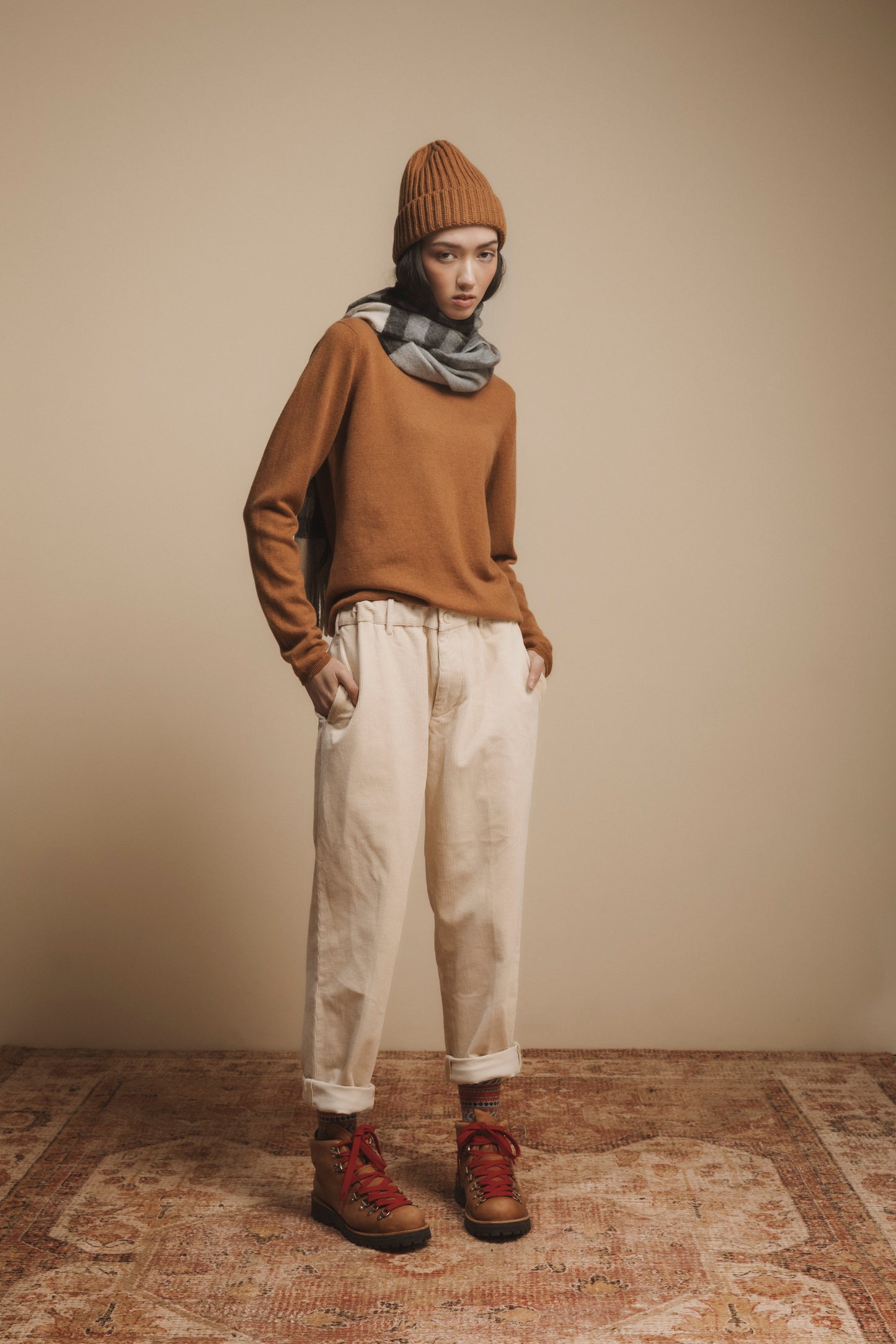 Made in Scotland Tartan 2 Cashmere Wide Scarf in Black Grey styled around the neck with a camel sweater and beanie