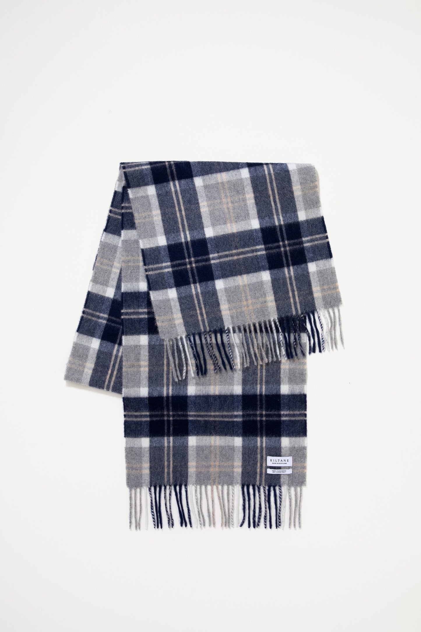 Heritage Cashmere Wide Scarf in Silver Bannockbane folded flat showing navy, grey, and white plaid pattern with fringed ends and Kiltane label