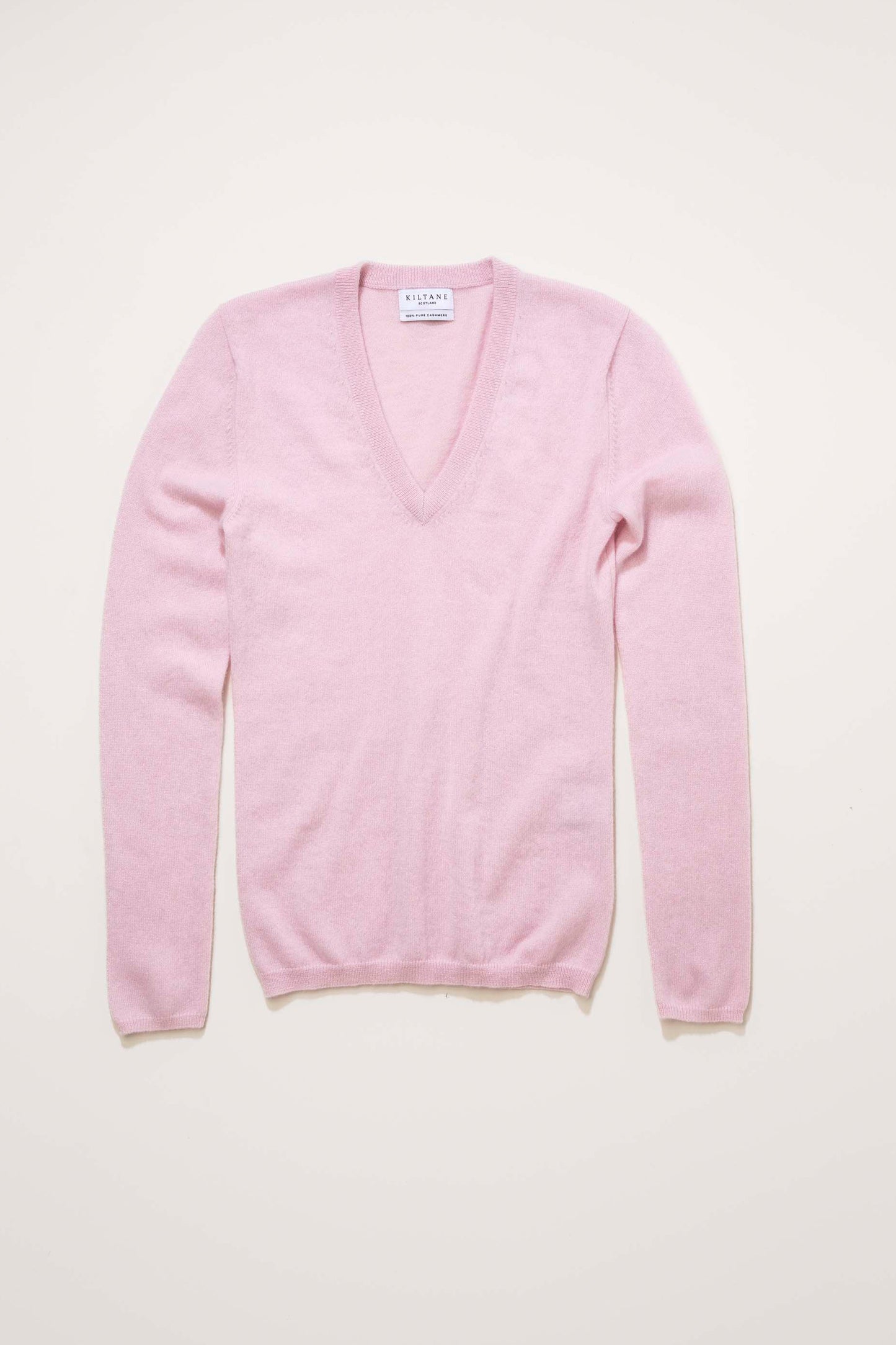 Women's Cashmere V Neck Jumper in Pale Lilac laid flat, showing front view with deep V neckline and Kiltane brand label
