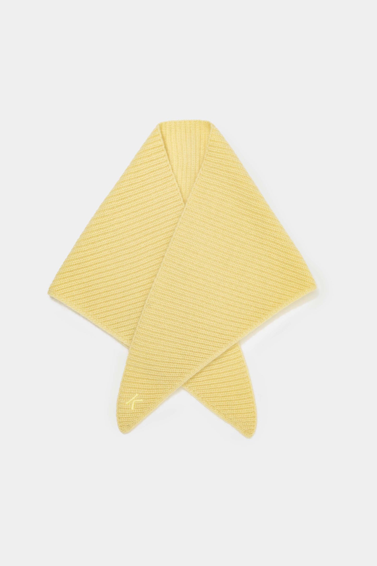 Knitted Cashmere Neck Tie in Lemon Sherbet folded flat showing ribbed diagonal knit texture and embroidered logo on tail