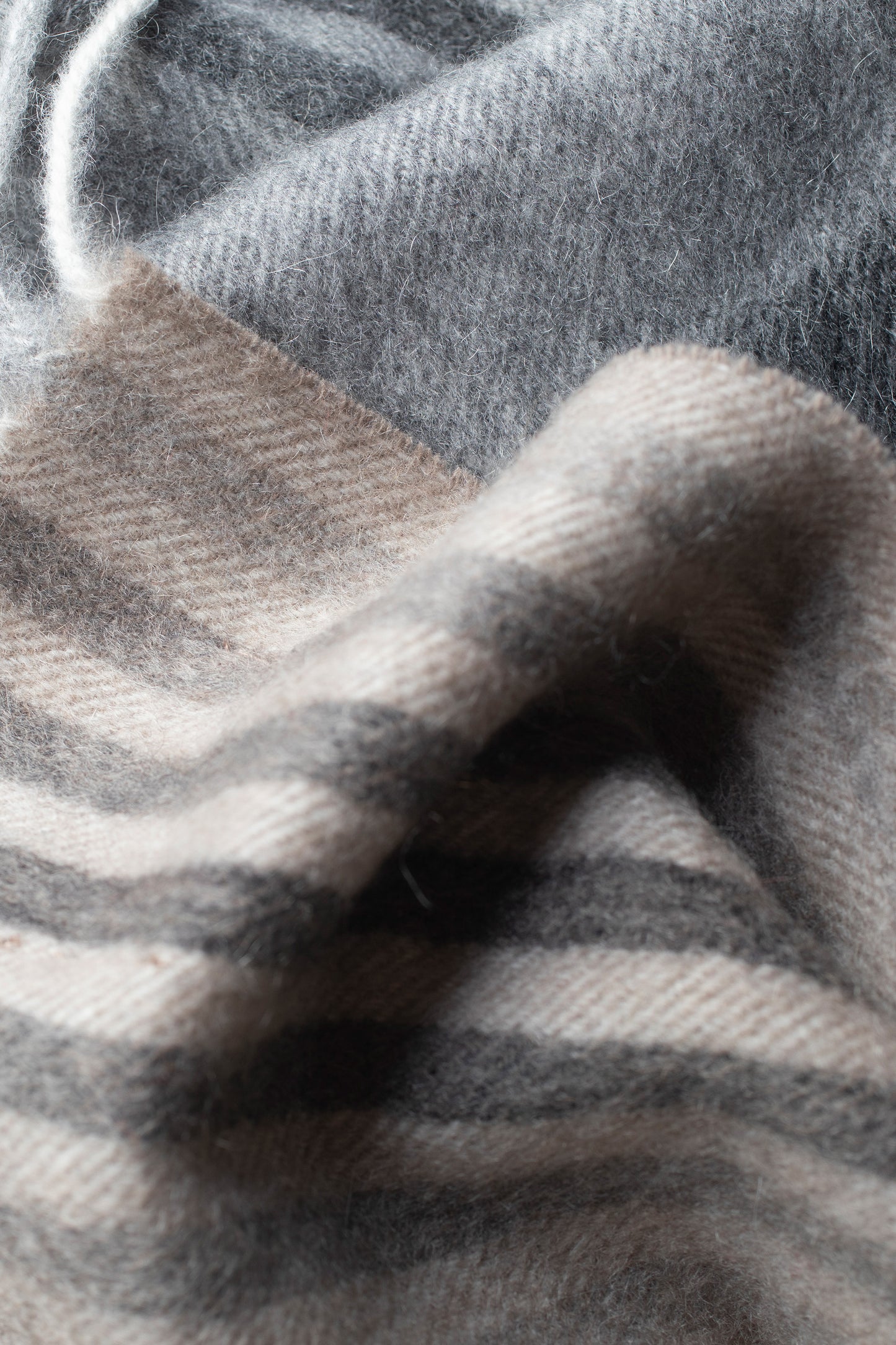 Close-up of Contemporary Check Cashmere Scarf in Monochrome showing soft brushed texture with grey and cream check pattern
