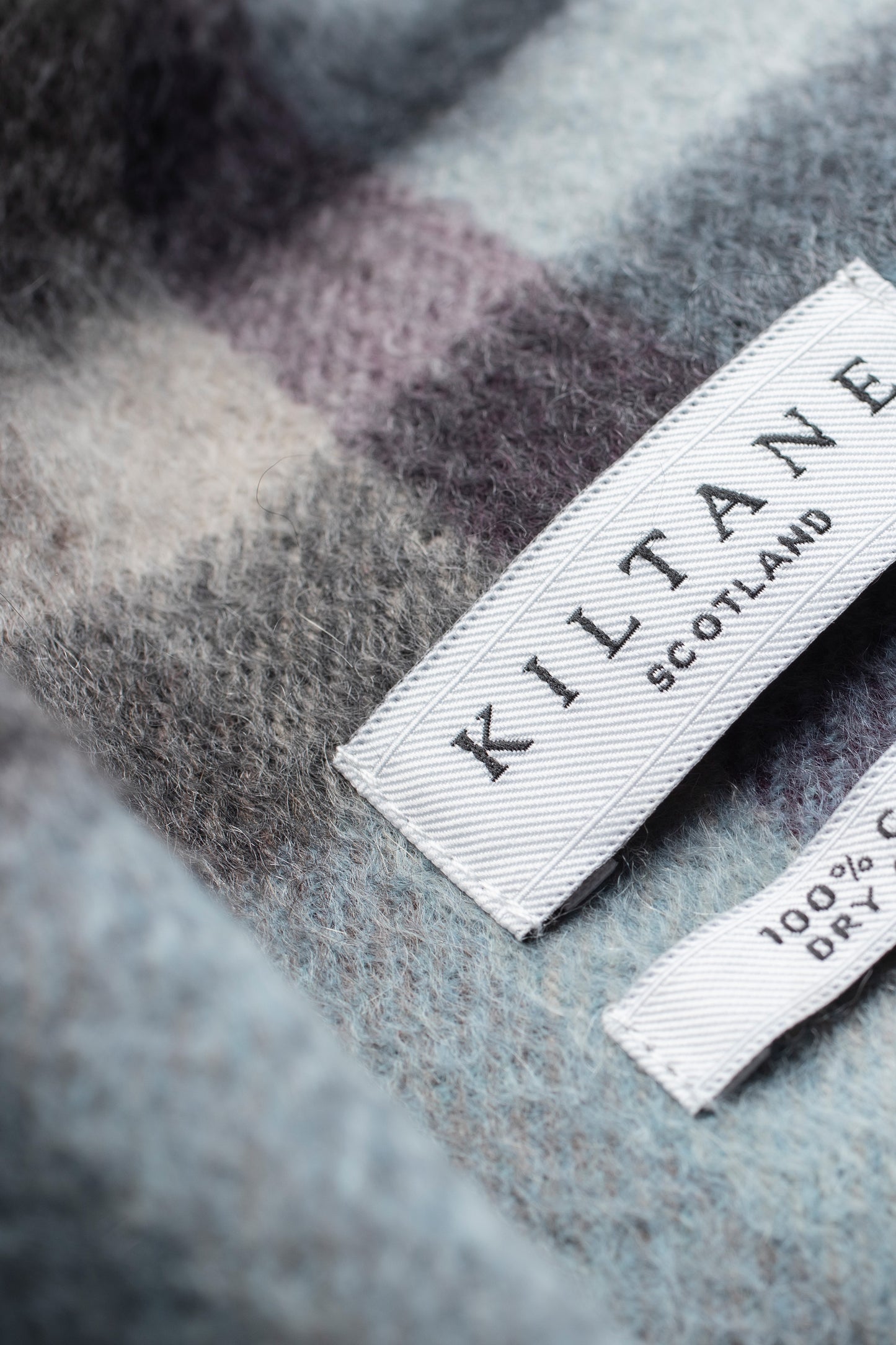 Close-up of Kiltane Scotland label on Tartan 2 Cashmere Scarf in Blue Taupe showing soft brushed cashmere texture