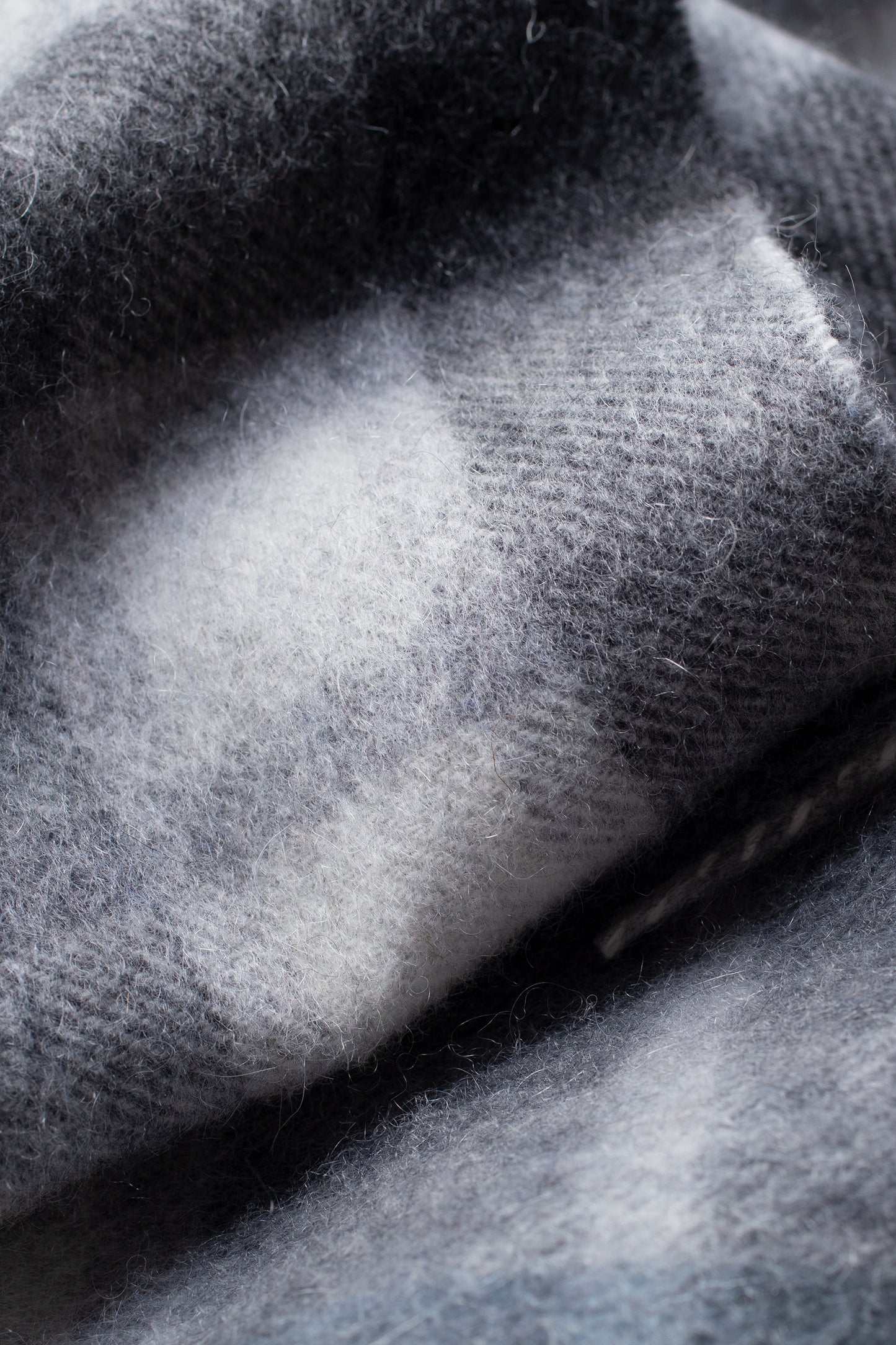 Close-up of the soft brushed cashmere texture on the Contemporary Check Cashmere Scarf in Ashley Blue