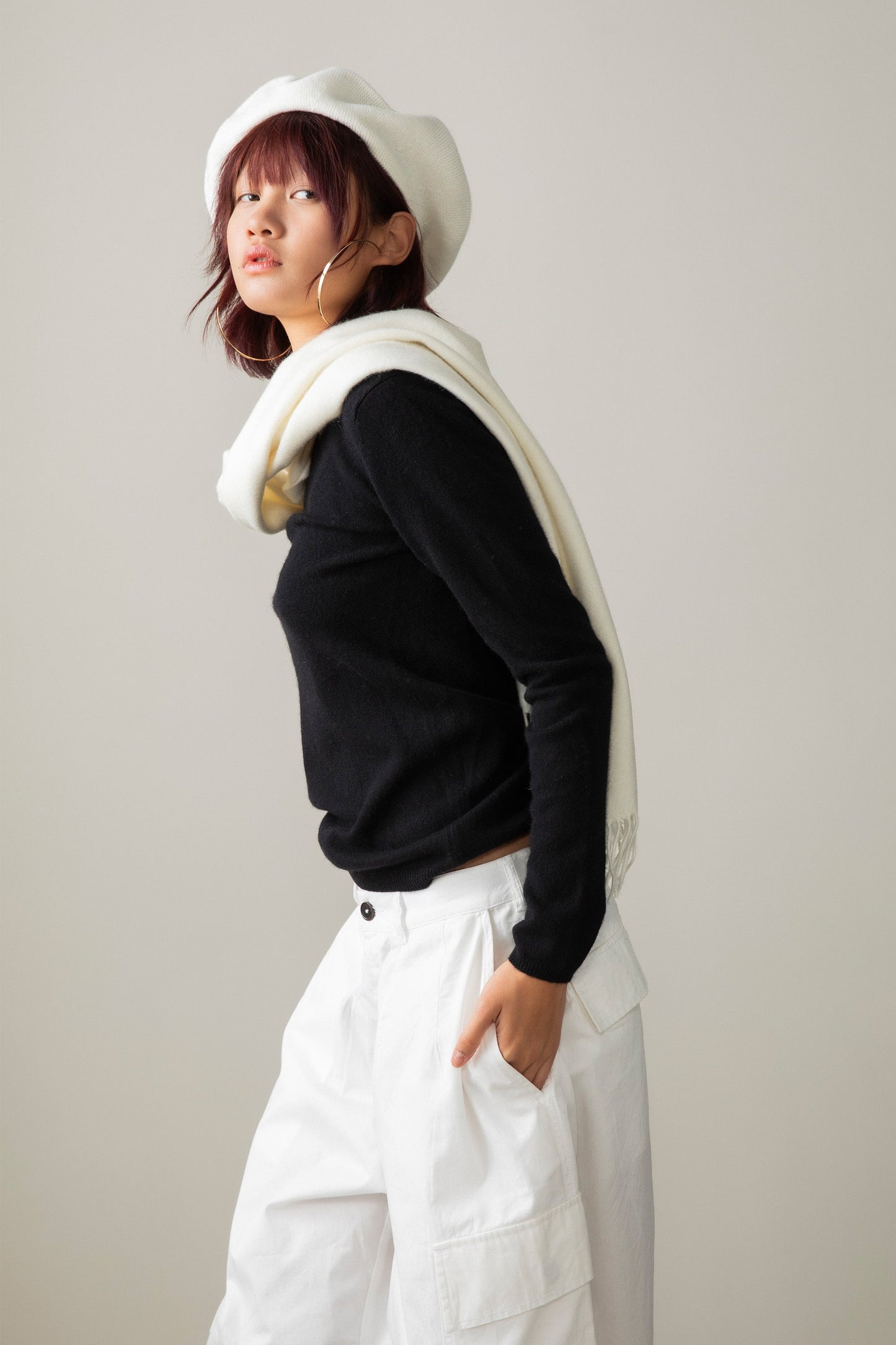 Solid Cashmere Wide Scarf in Soft Cream draped over shoulders, side profile showing its length against a black sweater