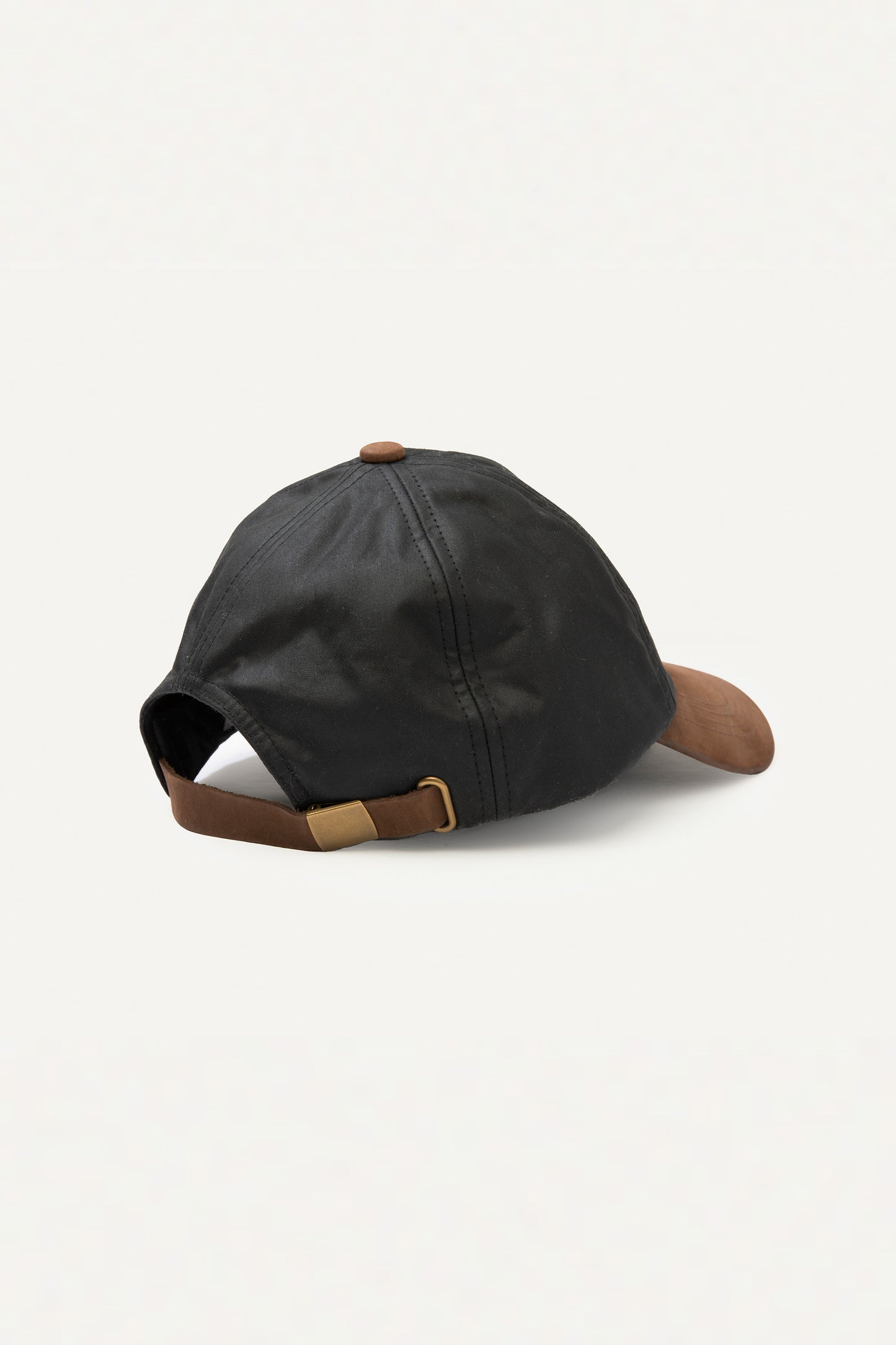 Back view of Wax Baseball Cap in black showing brown leather adjustable strap with brass buckle closure