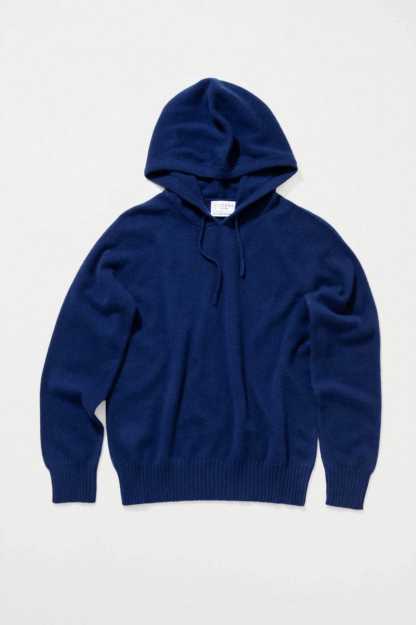 Unisex Cashmere Hoodie in Eclipse navy blue laid flat, showing front view with drawstring hood and ribbed cuffs