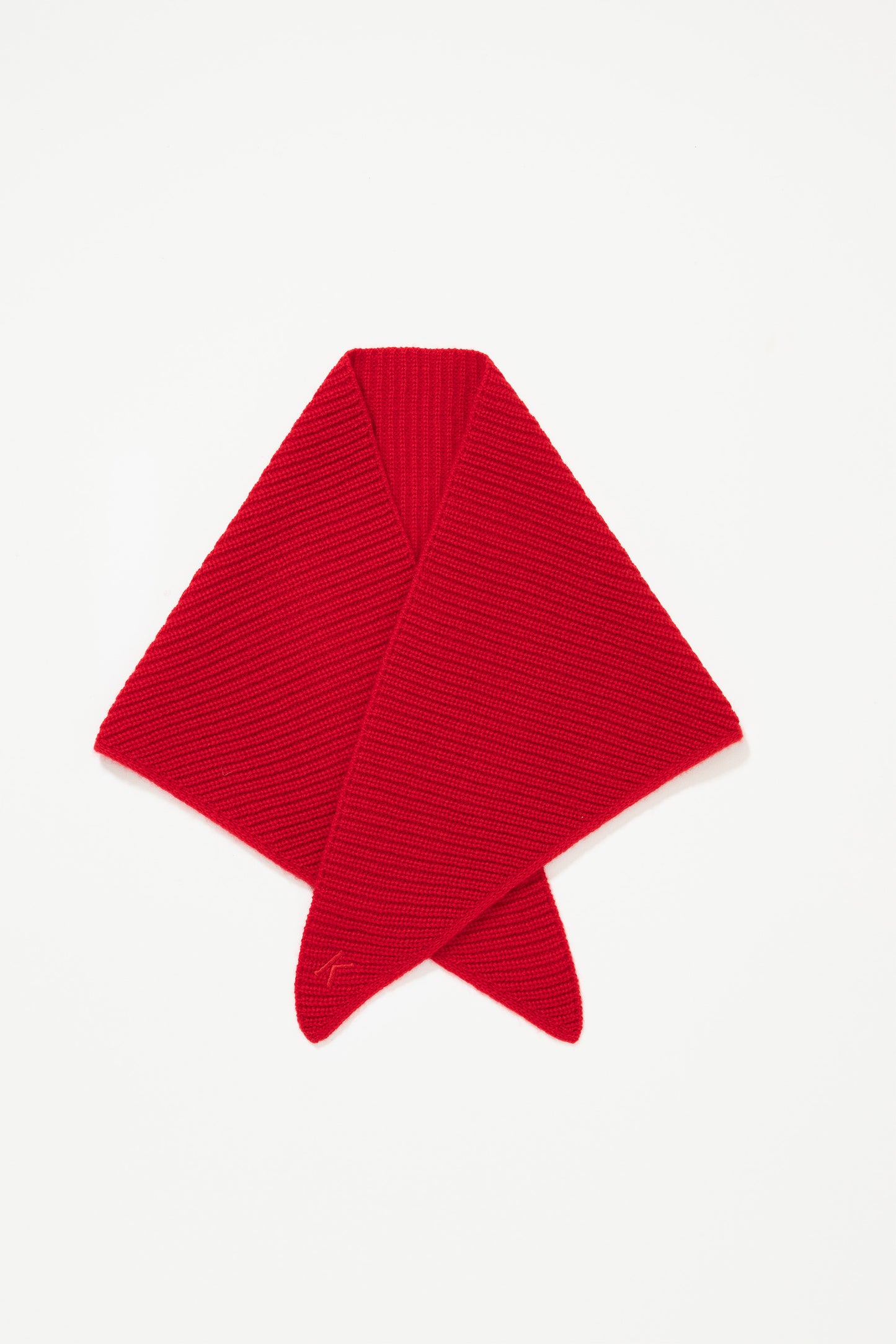 Knitted Cashmere Neck Tie in red, folded flat showing diagonal ribbed knit texture and embroidered logo detail