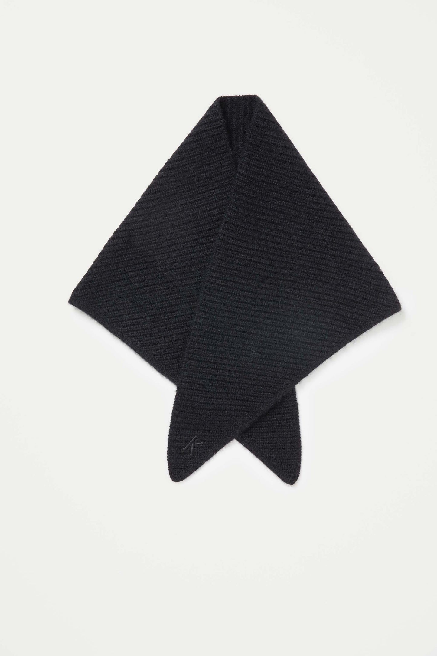 Knitted Cashmere Neck Tie in black laid flat in diamond shape, showing ribbed texture and embroidered logo on point