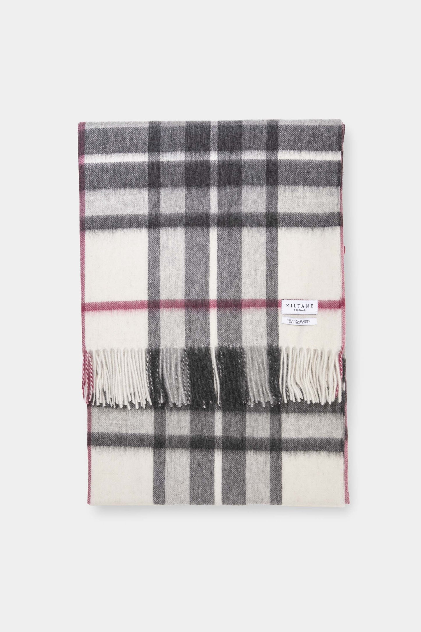 Kiltane Lambswool Throw in White Scotty Thompson tartan with grey, white, and pink check pattern and fringed edges