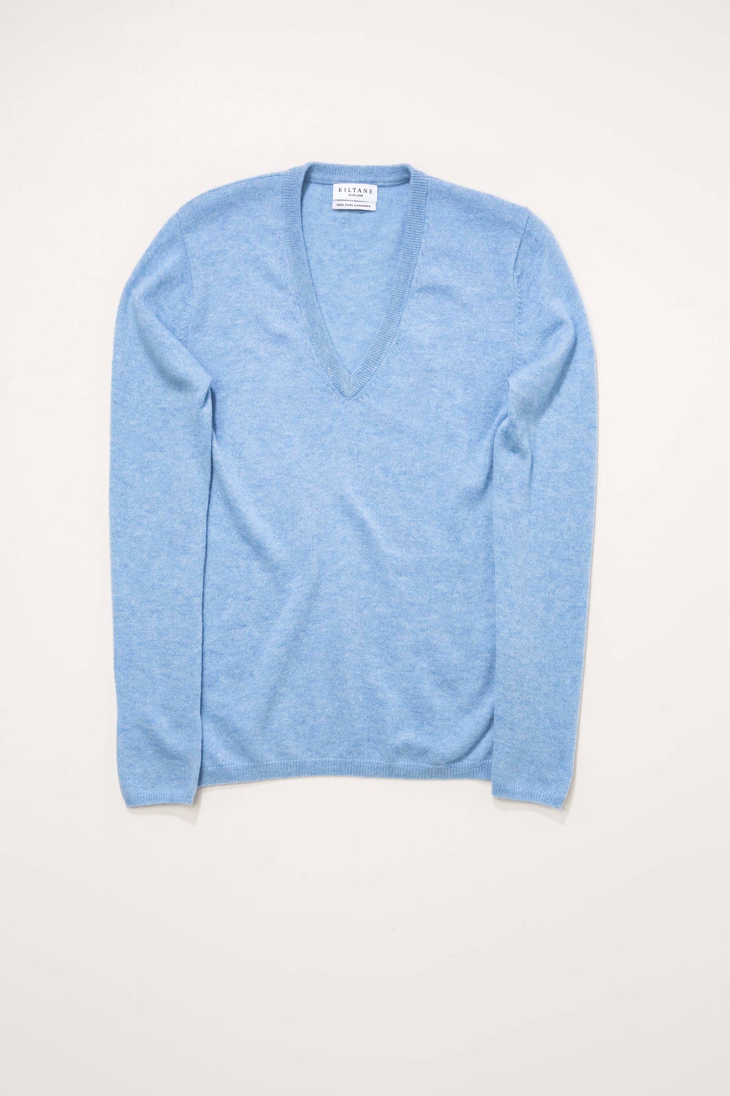 Kiltane Women's Cashmere V Neck Jumper in Glacier blue, flat lay front view showing deep V-neckline and fine knit texture