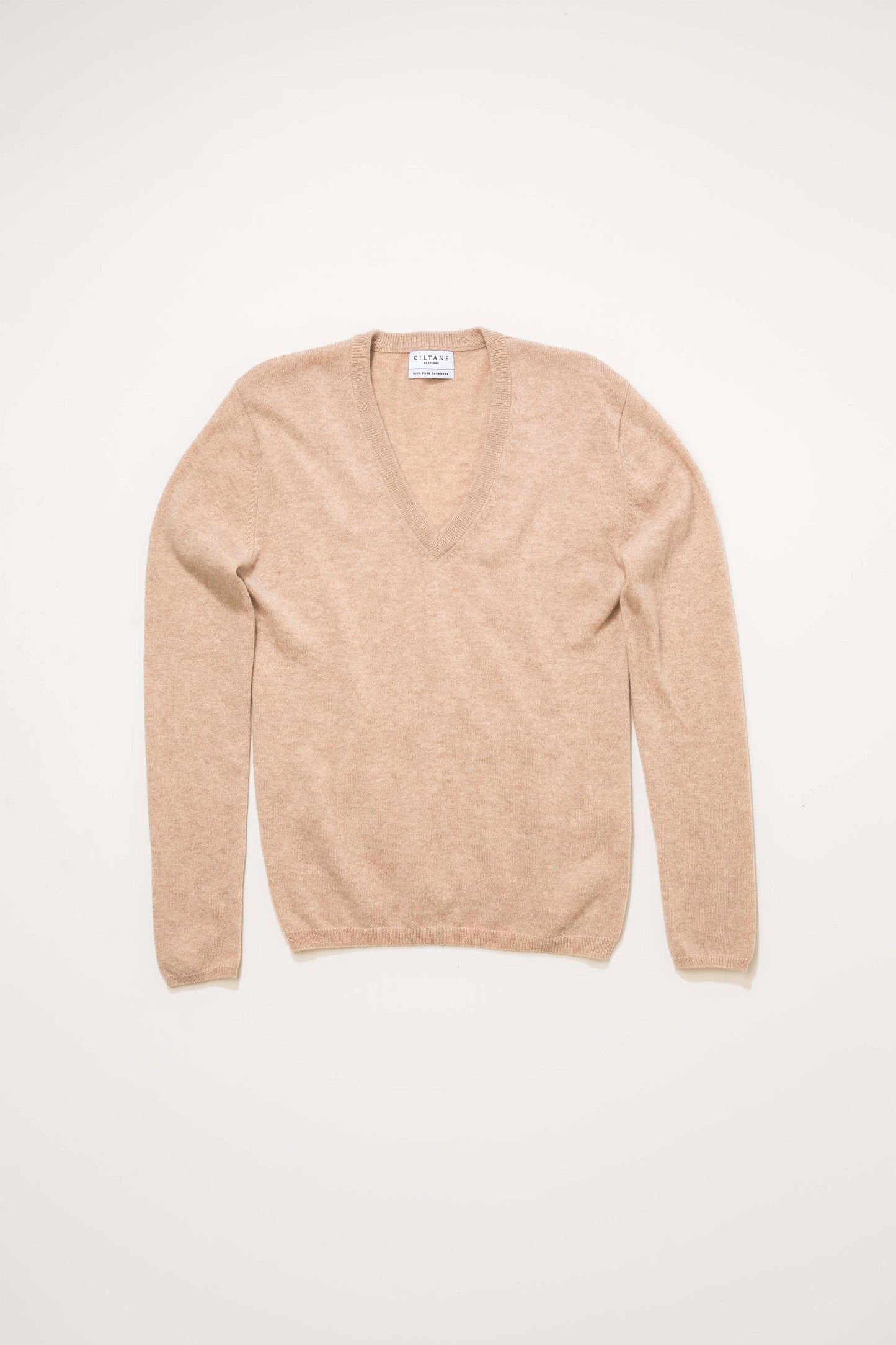 Women's Cashmere V Neck Jumper in Vicuna laid flat, showing the soft camel-toned knit and deep V neckline with Kiltane label
