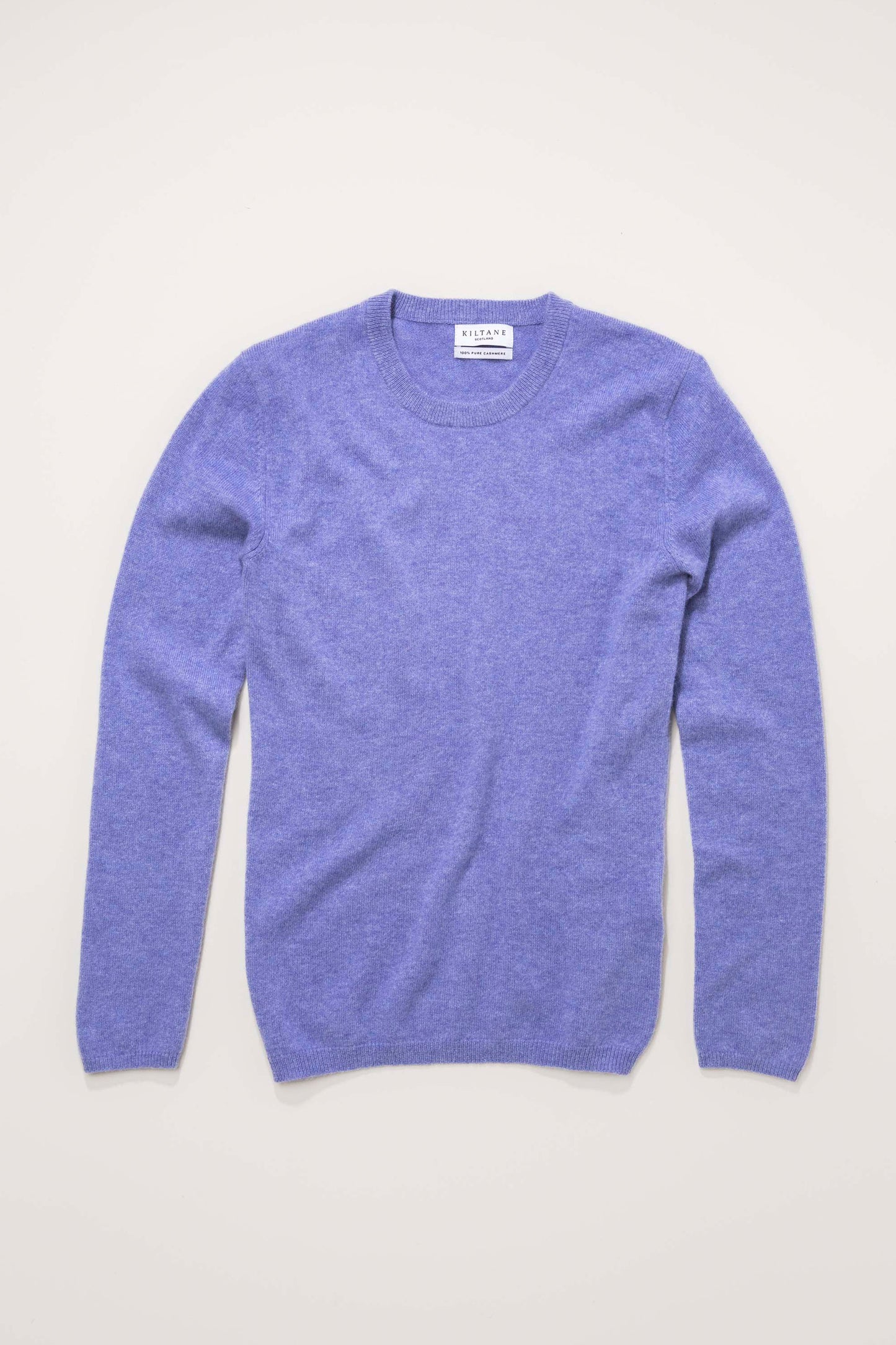 Kiltane Women's Cashmere Crew Neck Jumper in Wisteria laid flat, showing front view with ribbed neckline and cuffs