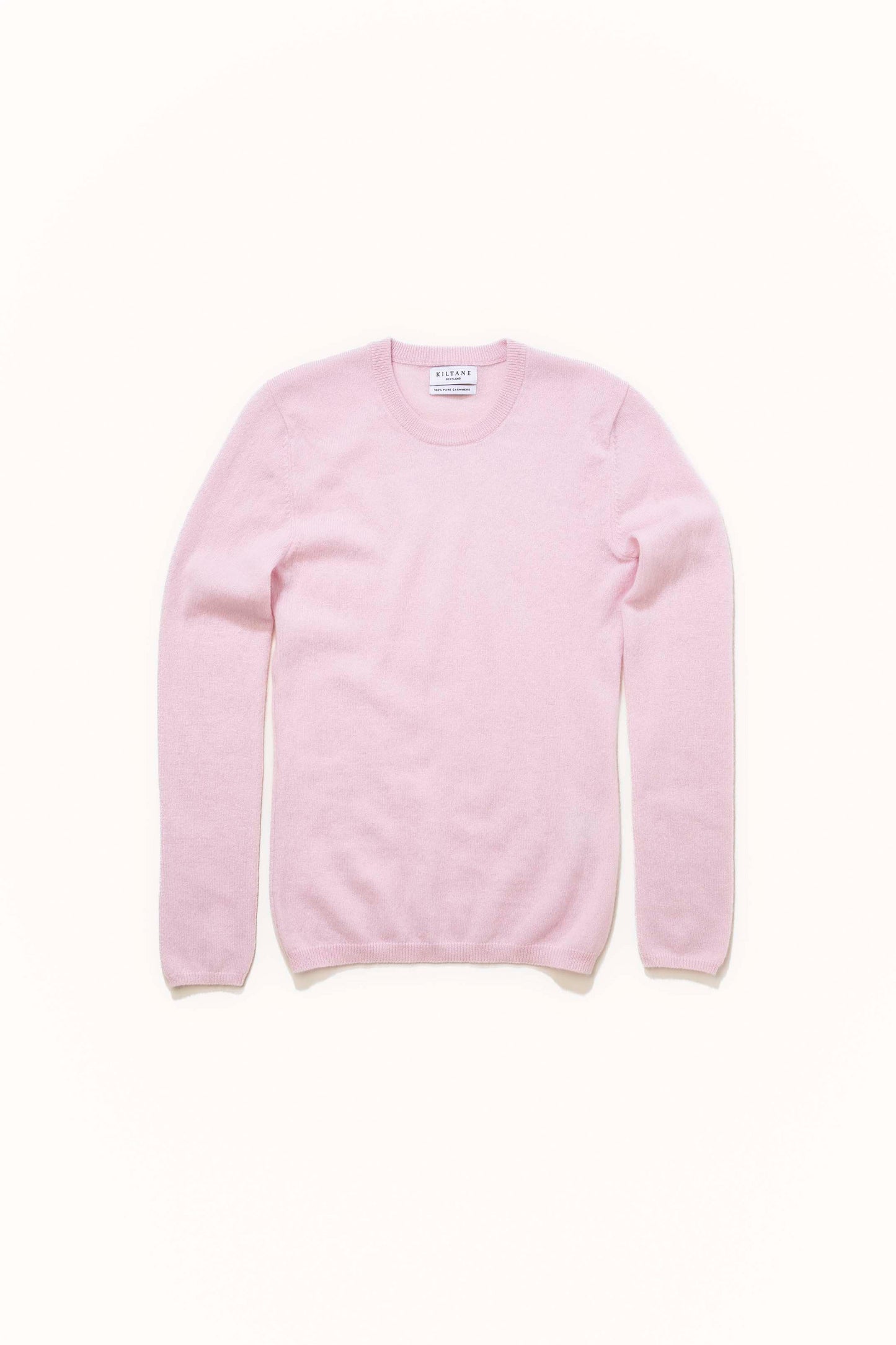 Kiltane Women's Cashmere Crew Neck Jumper in Pale Lilac laid flat, showing front view with ribbed cuffs and hem