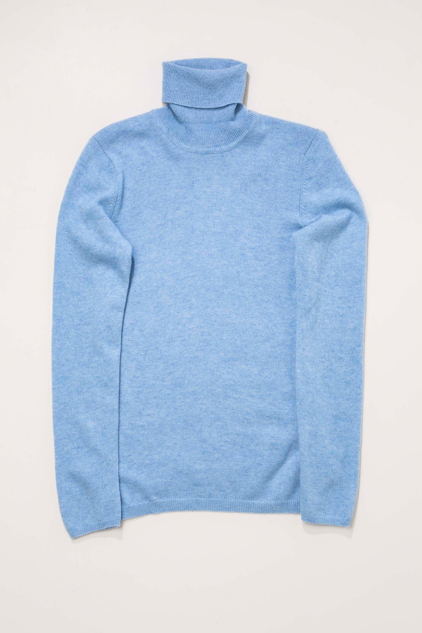Women's Cashmere Polo Neck Jumper in Glacier blue, flat lay front view showing soft knit texture and folded turtleneck