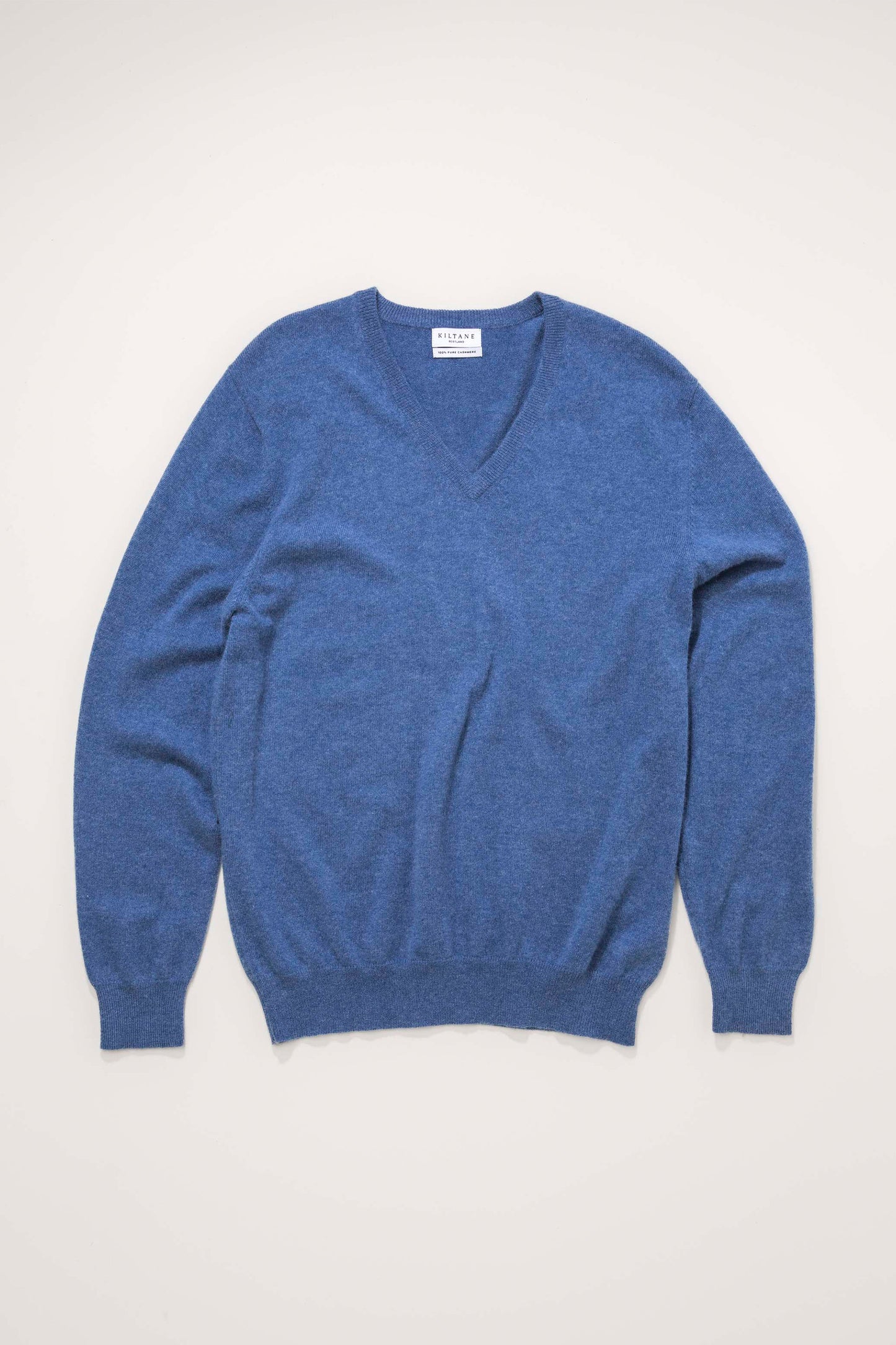 Men's Cashmere V Neck Jumper in Denim blue, flat lay front view showing soft knit texture and ribbed cuffs