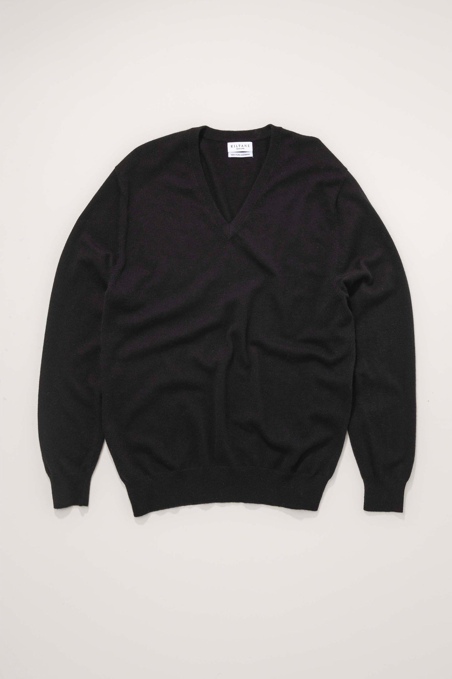 Kiltane Men's Cashmere V Neck Jumper in black, flat lay showing full front with ribbed cuffs and hem