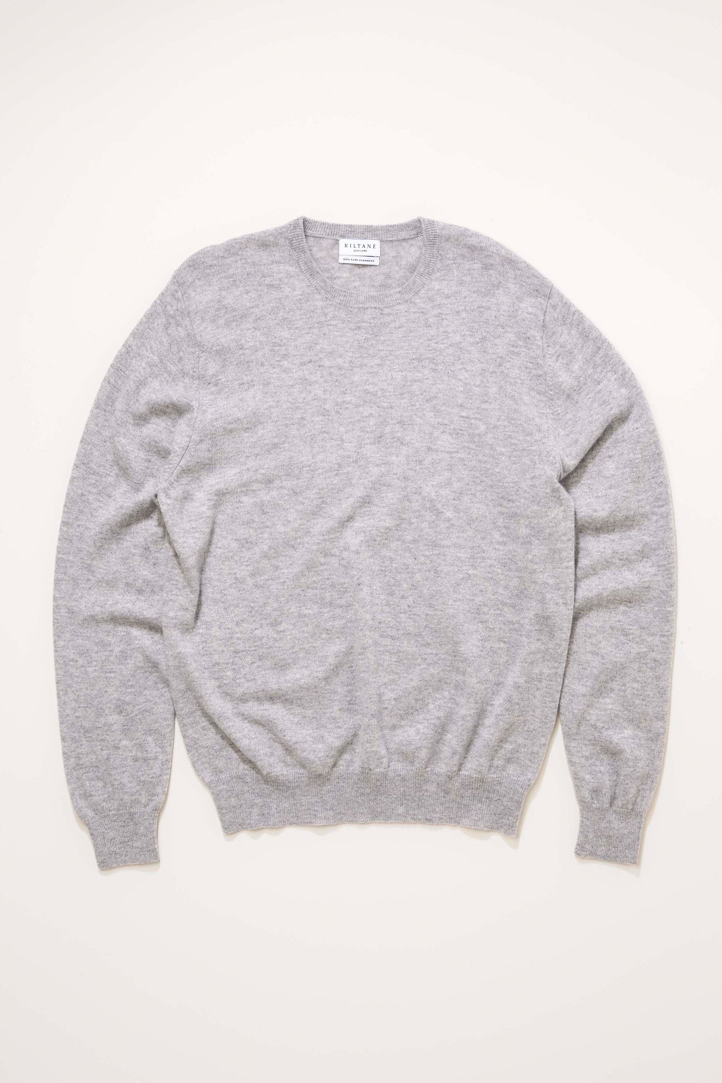 Men's Cashmere Crew Neck Jumper in Light Grey laid flat, showing full front view with ribbed cuffs and hem