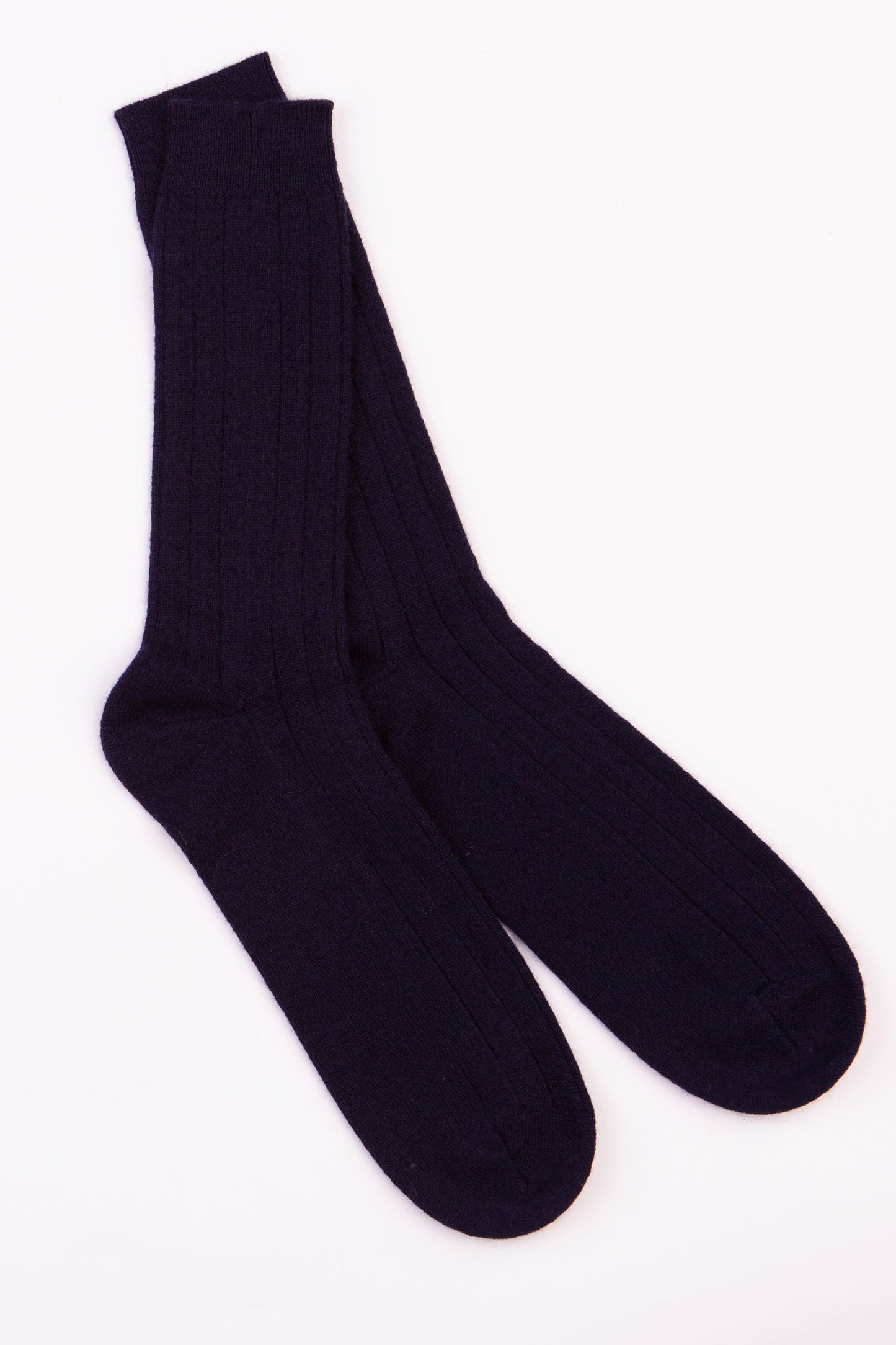 Men's Cashmere Bed Socks in navy, pair laid flat showing ribbed knit texture and mid-calf length