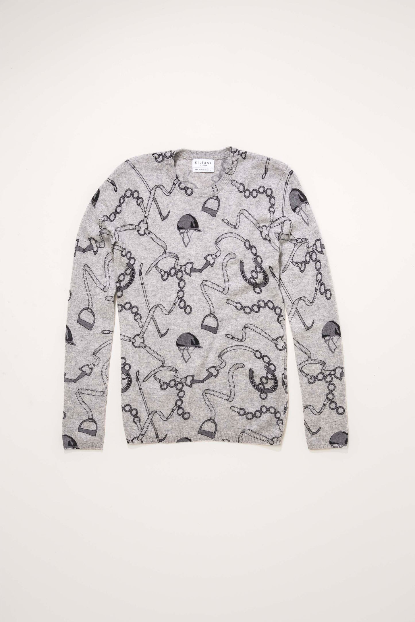 Women's Equestrian Print Crew Neck Jumper in Oyster Grey laid flat, showing all-over horseshoe, helmet, and riding tack pattern