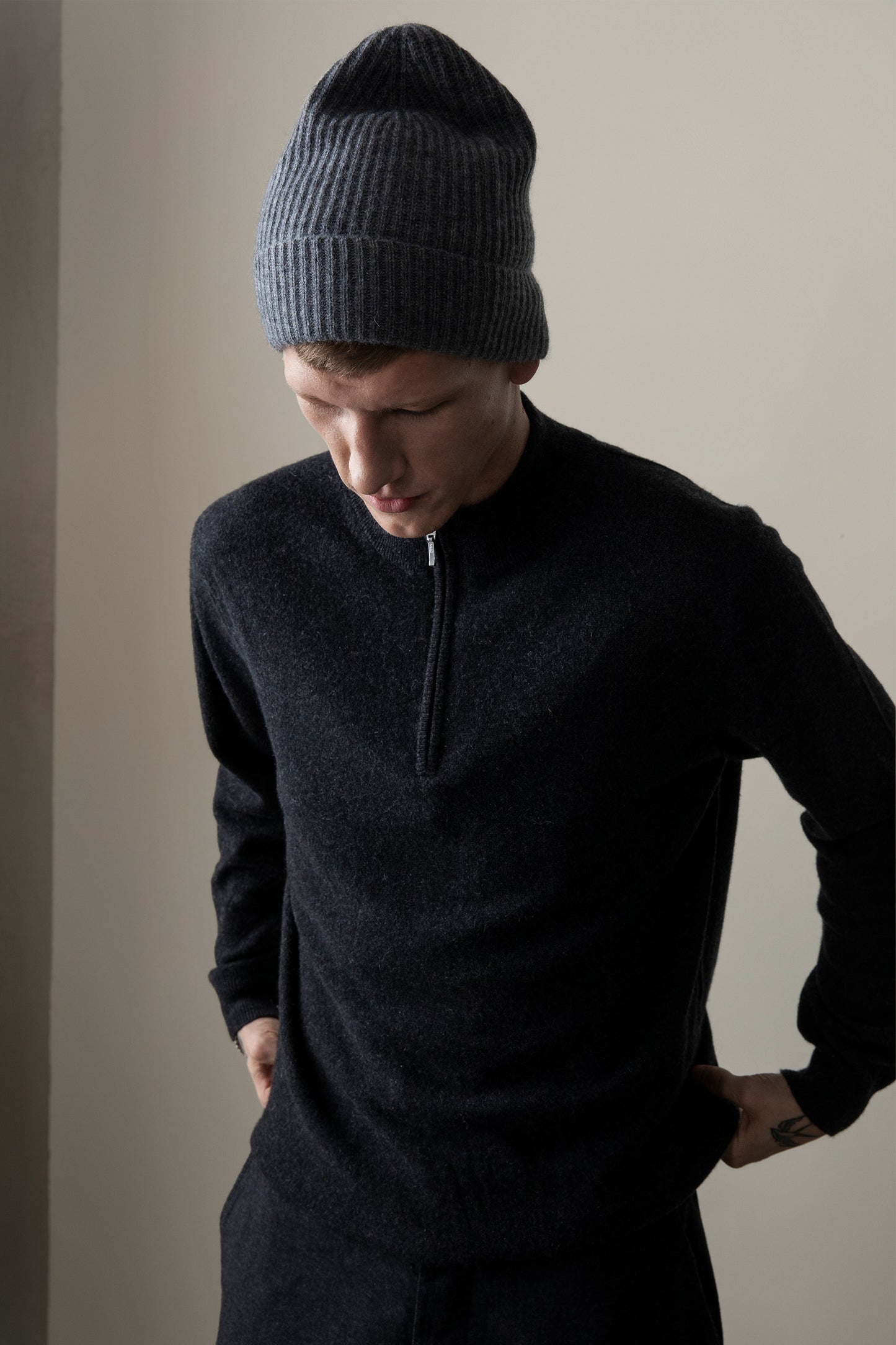 Men's Half Zip Jumper in charcoal cashmere worn by model, showing front zip detail and relaxed fit