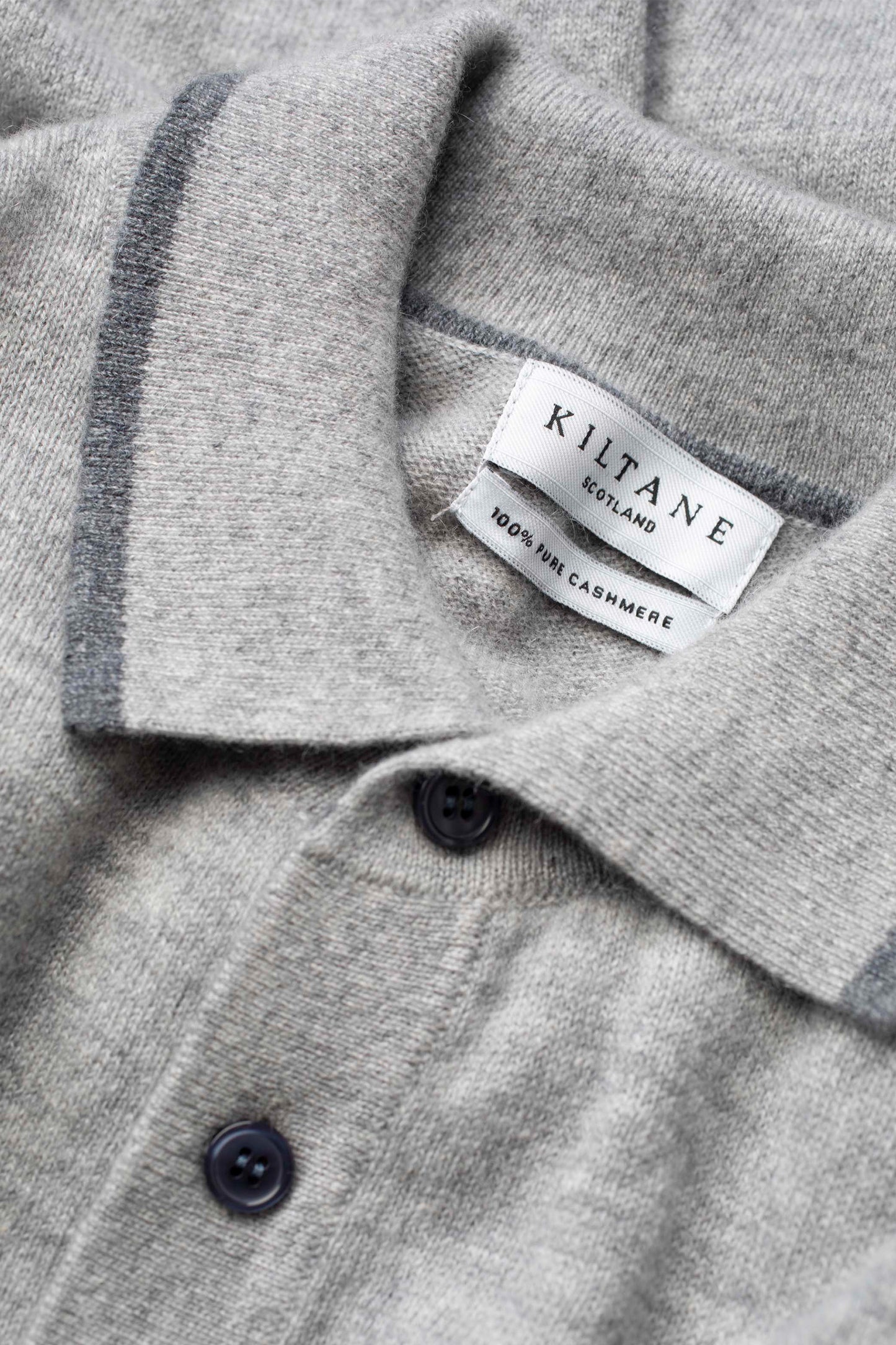Close-up of Kiltane Scotland collar and brand label on Men's Long Sleeved Knitted Polo Shirt in Oyster Grey, 100% pure cashmere