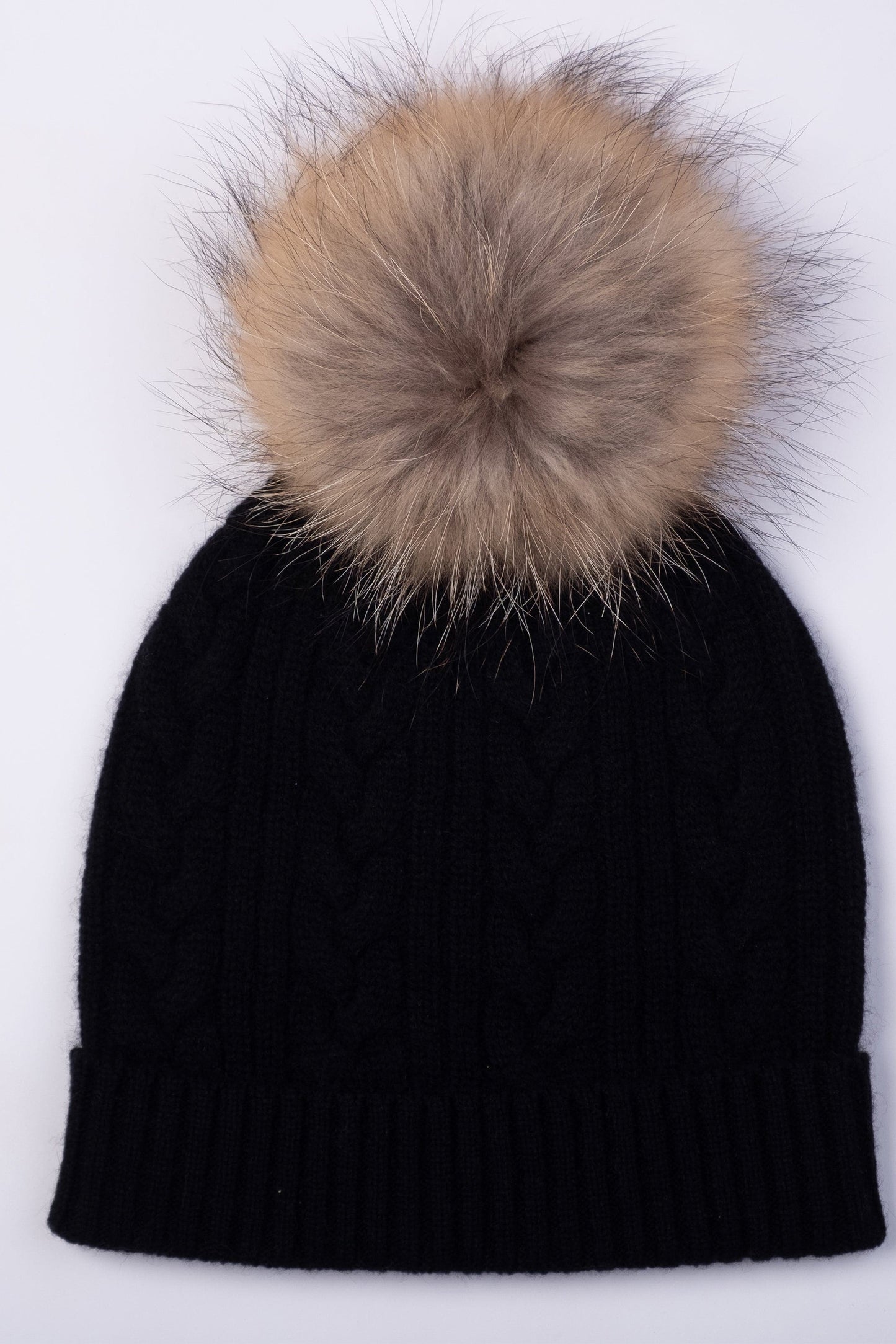 Cable Knit Pom Pom Hat - Black flat lay showing cable knit pattern detail and oversized natural fur pom pom