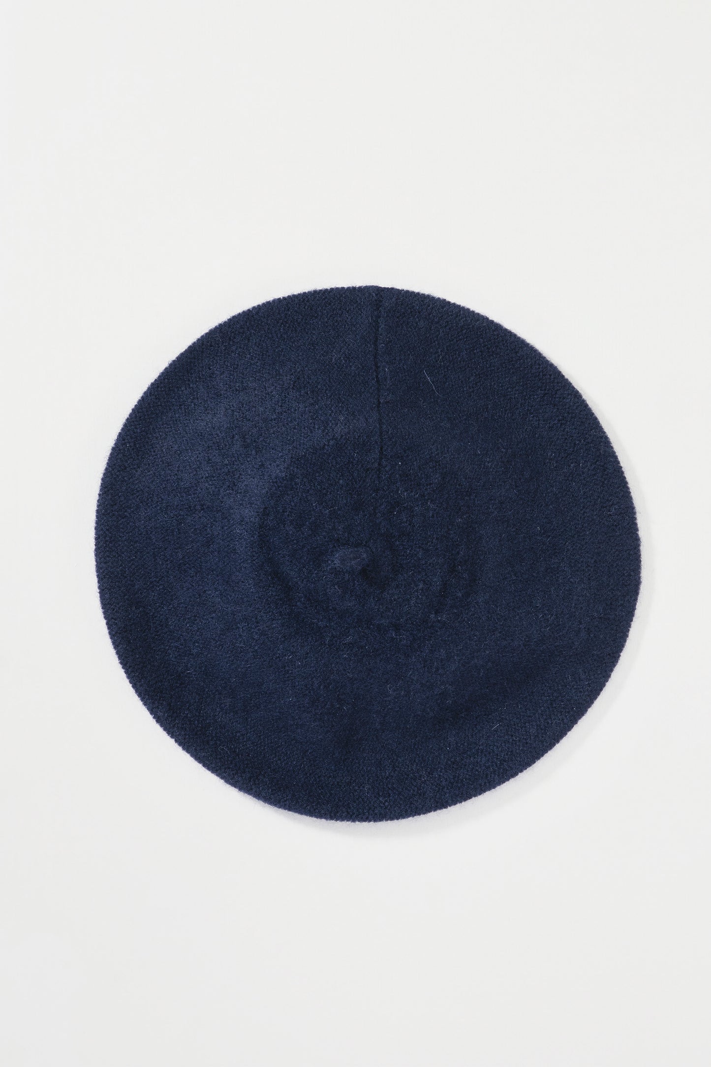 Cashmere Knitted Beret in Dark Navy laid flat, top-down view showing the round shape and centre seam detail