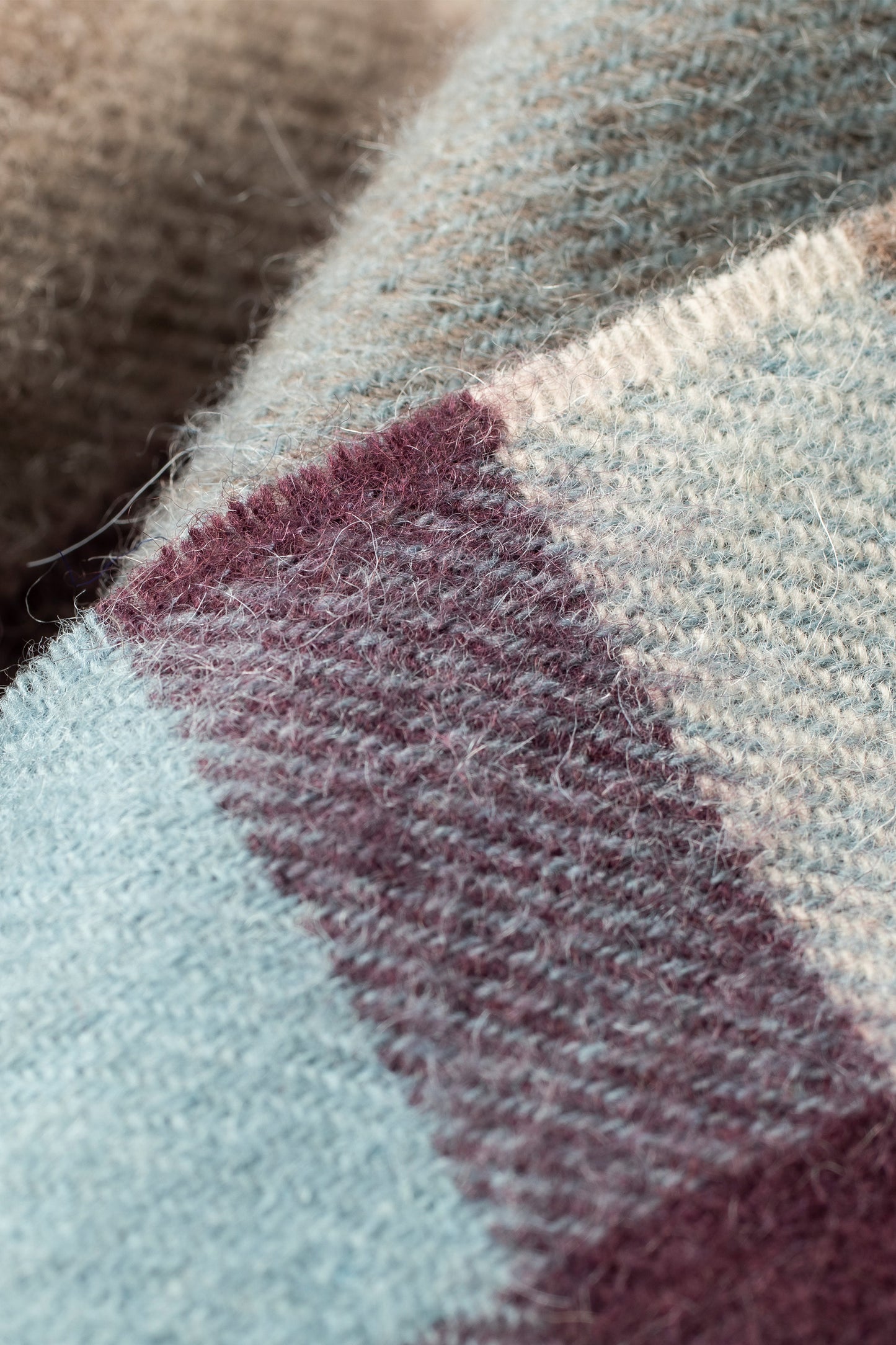 Close-up of Tartan 2 Lambswool Scarf showing soft woven texture with blue, burgundy, cream, and taupe check pattern