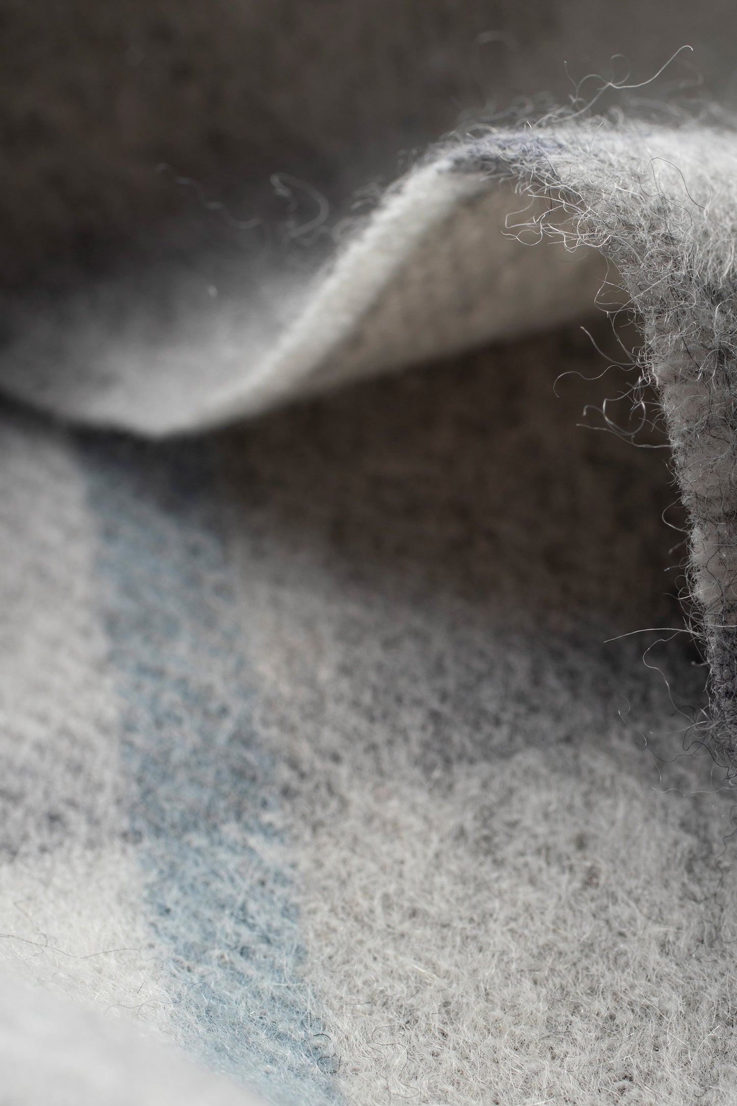 Close-up of Princeton Check Lambswool Scarf in Blue showing soft brushed wool texture and grey-blue check pattern