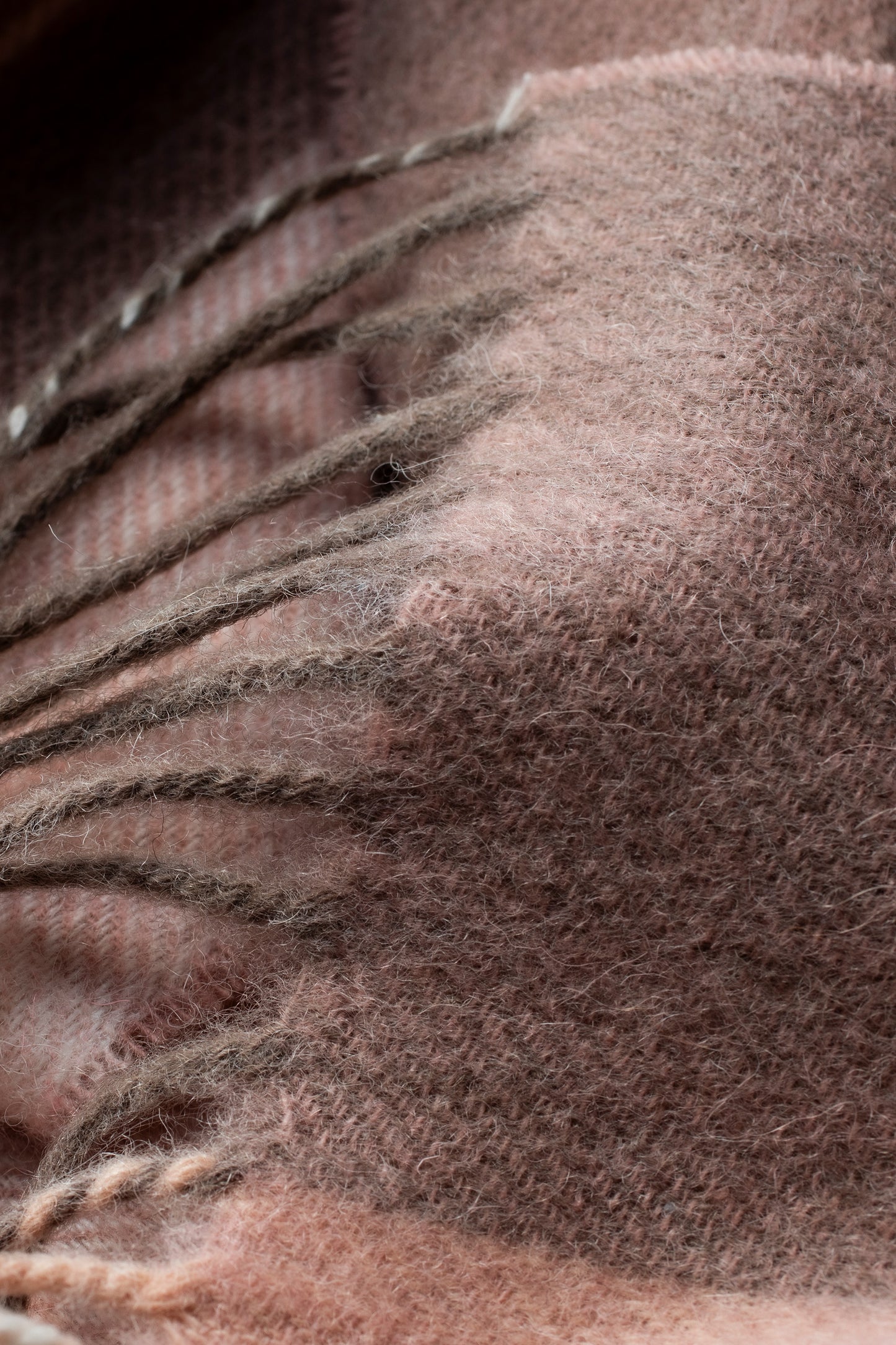 Close-up of Contemporary Check Lambswool Scarf in Cameo showing soft brushed texture and pink-brown woven fibres