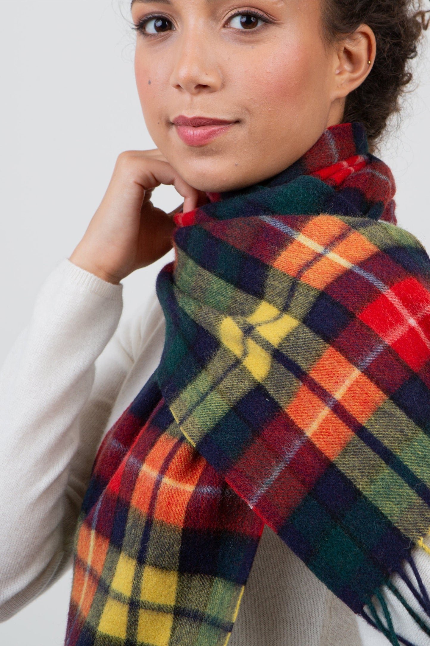 Heritage Tartan Lambswool Scarf in Buchanan Modern worn wrapped around the neck, showing vibrant red, green, yellow, and navy plaid