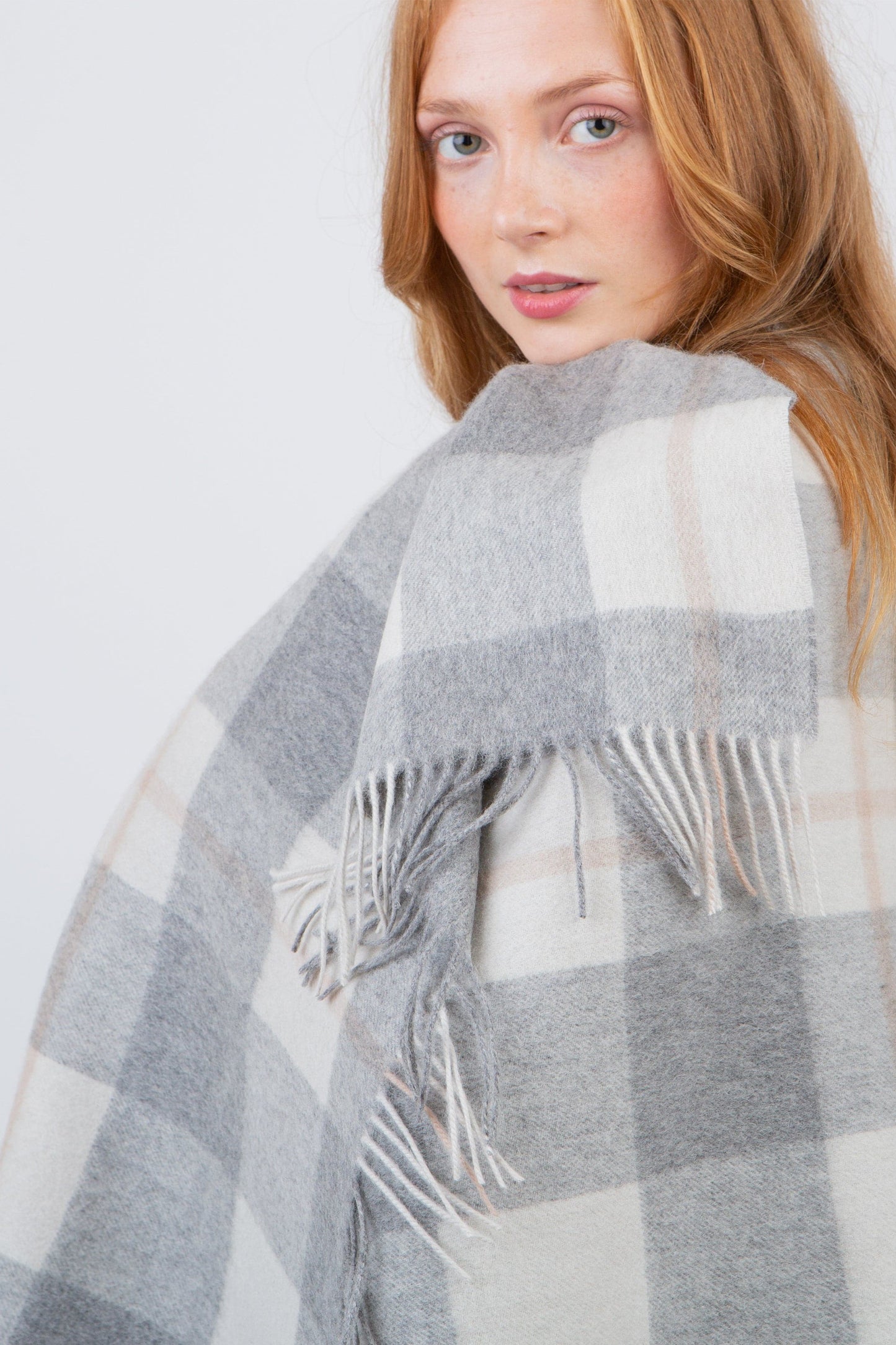 Contemporary Check Lambswool Stole in Grey draped over shoulders, showing fringed edge detail and soft check pattern