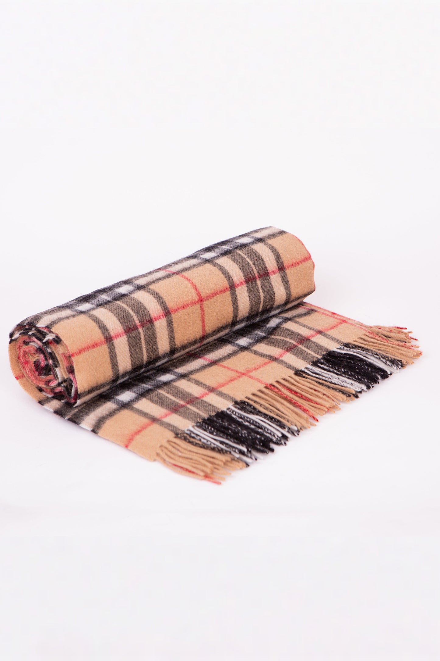 Lambswool Throw in Scotty Camel Thompson tartan, rolled and partially unrolled showing camel, black, red, and white plaid with fringed edges