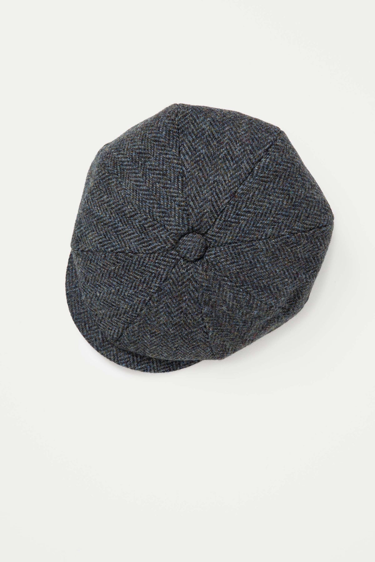 Harris Tweed Carloway Hat in Blue Mix Herringbone viewed from above, showing eight-panel crown and centre button detail
