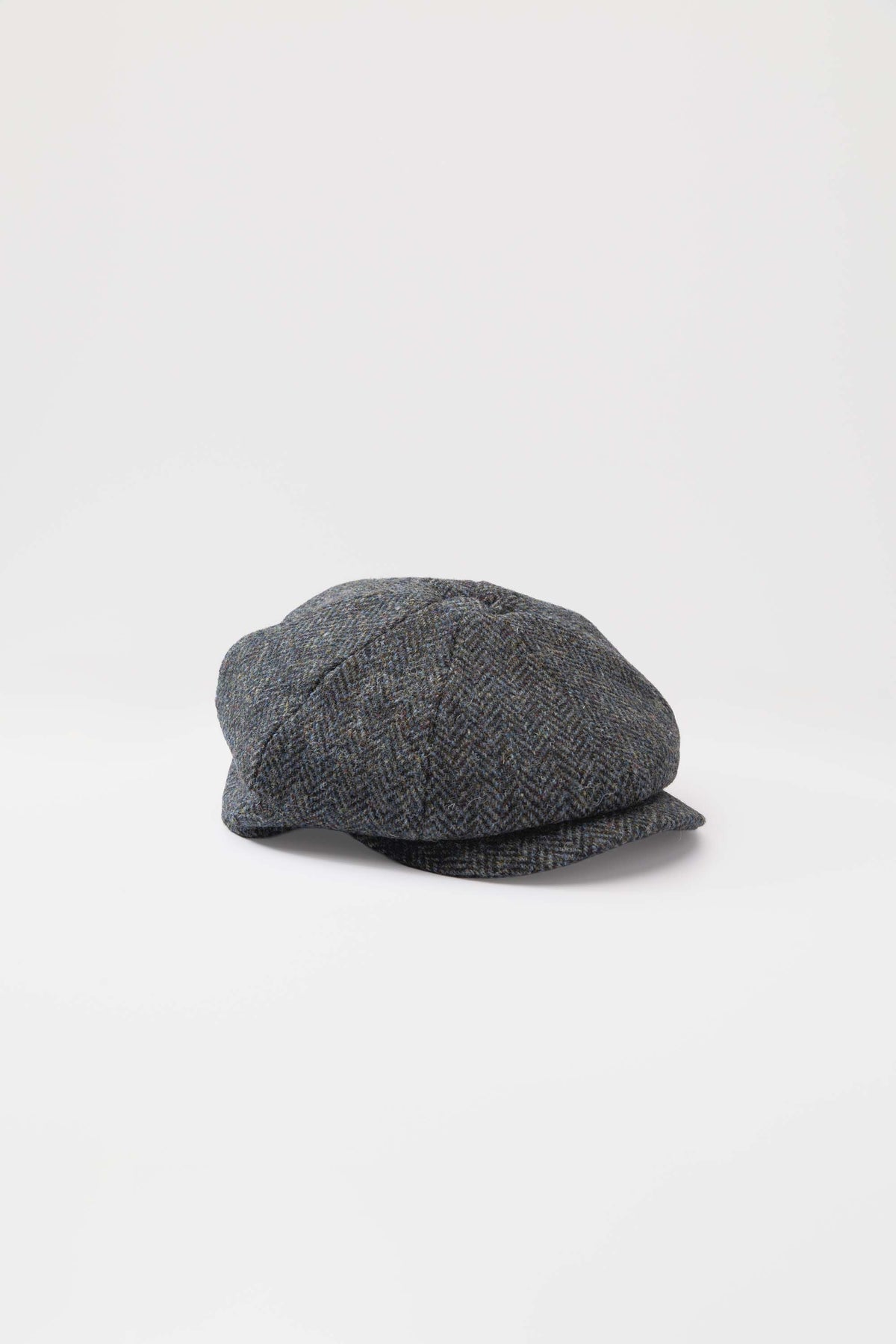 Harris Tweed Carloway Hat in Blue Mix Herringbone, front-angled view showing eight-panel newsboy crown and short brim