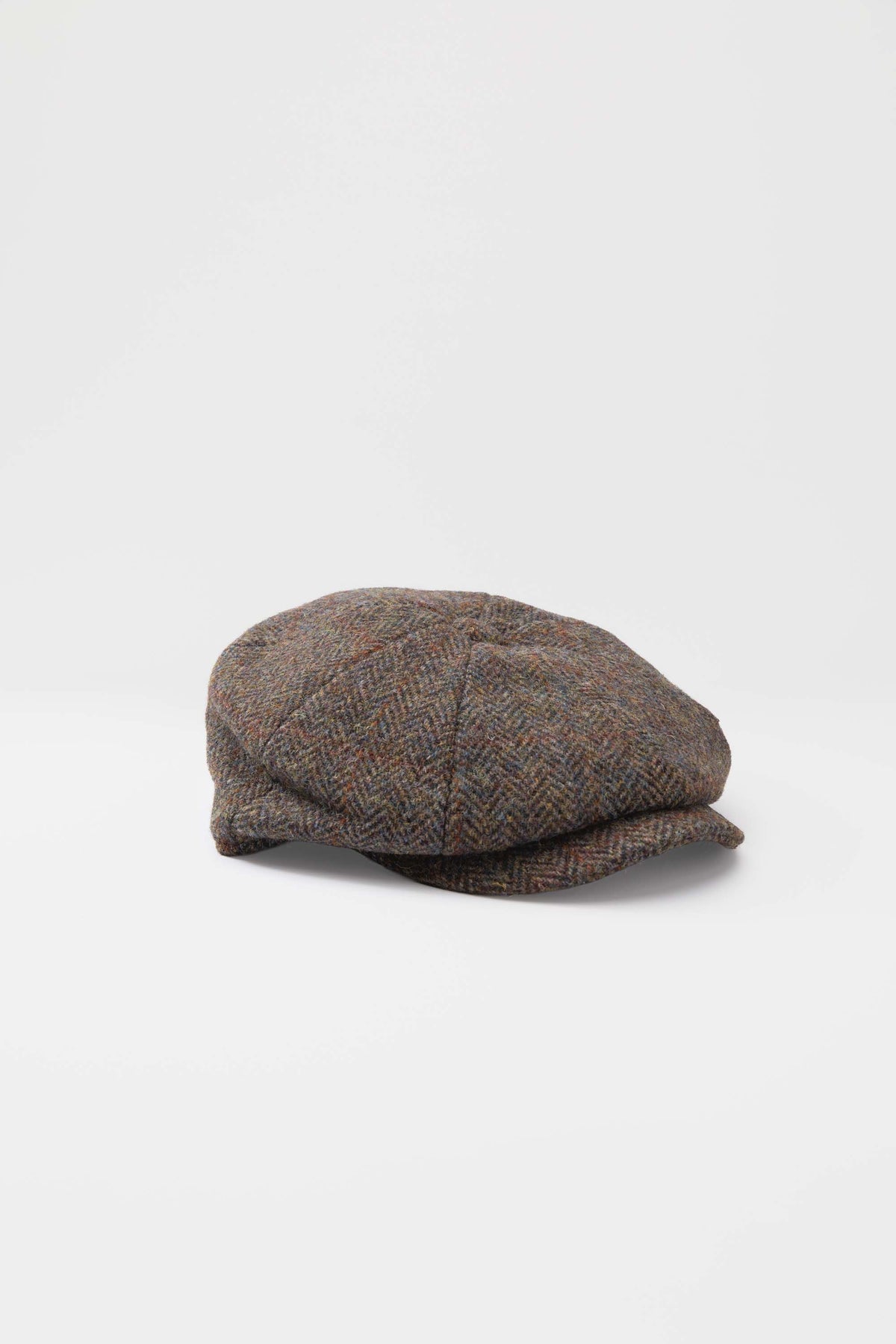 Harris Tweed Carloway Hat in brown check herringbone, side view showing eight-panel crown and short brim
