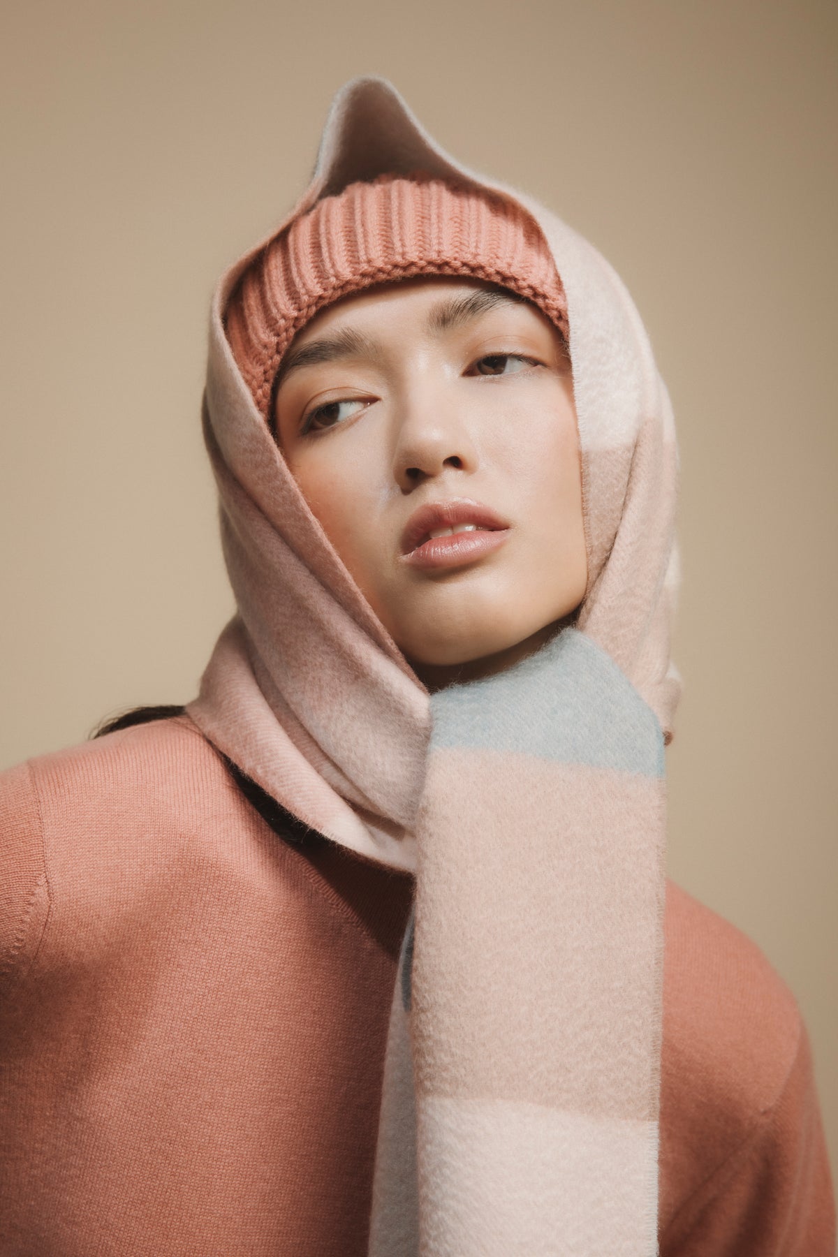3 Square Check Cashmere Wide Scarf in Seashell worn as a headwrap, soft pink and pale blue check pattern