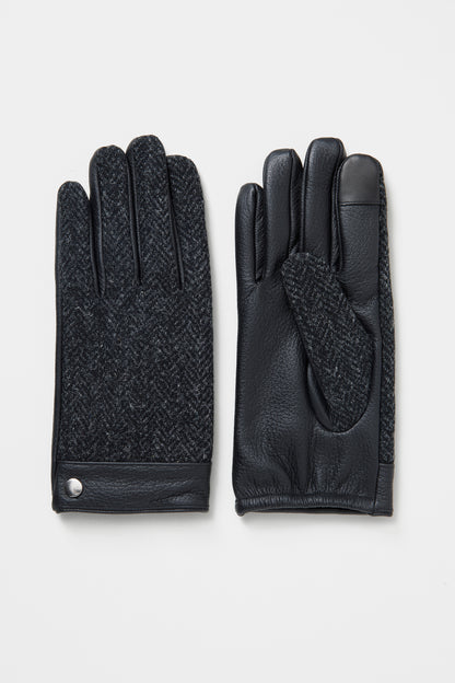 Men's Harris Tweed Gloves in Deep Charcoal showing herringbone tweed back and black leather palm with silver snap detail