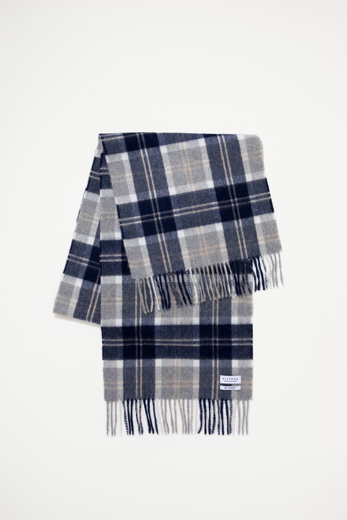 Heritage Cashmere Wide Scarf in Silver Bannockbane folded flat showing navy, grey, and white plaid pattern with fringed ends and Kiltane label