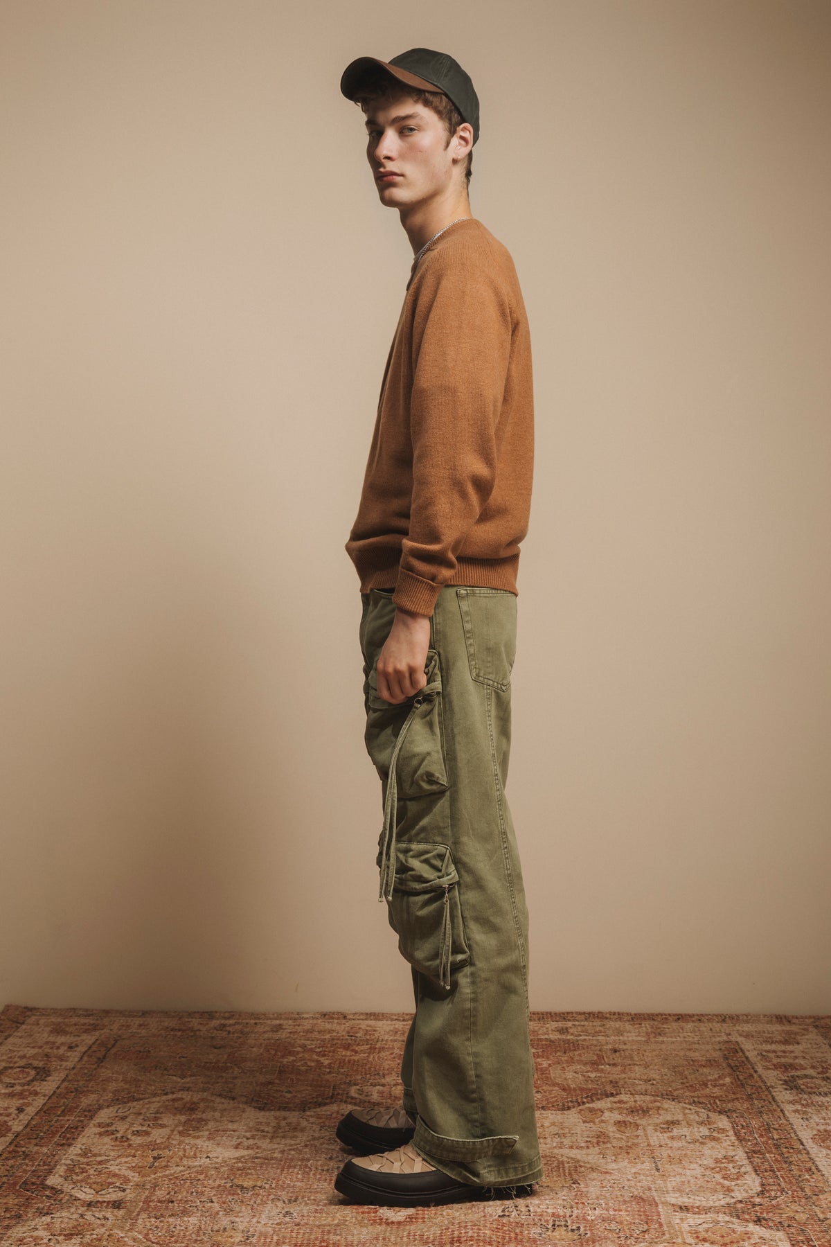 Wax Baseball Cap in olive worn by model in side profile, showing the low-profile curved brim and relaxed fit