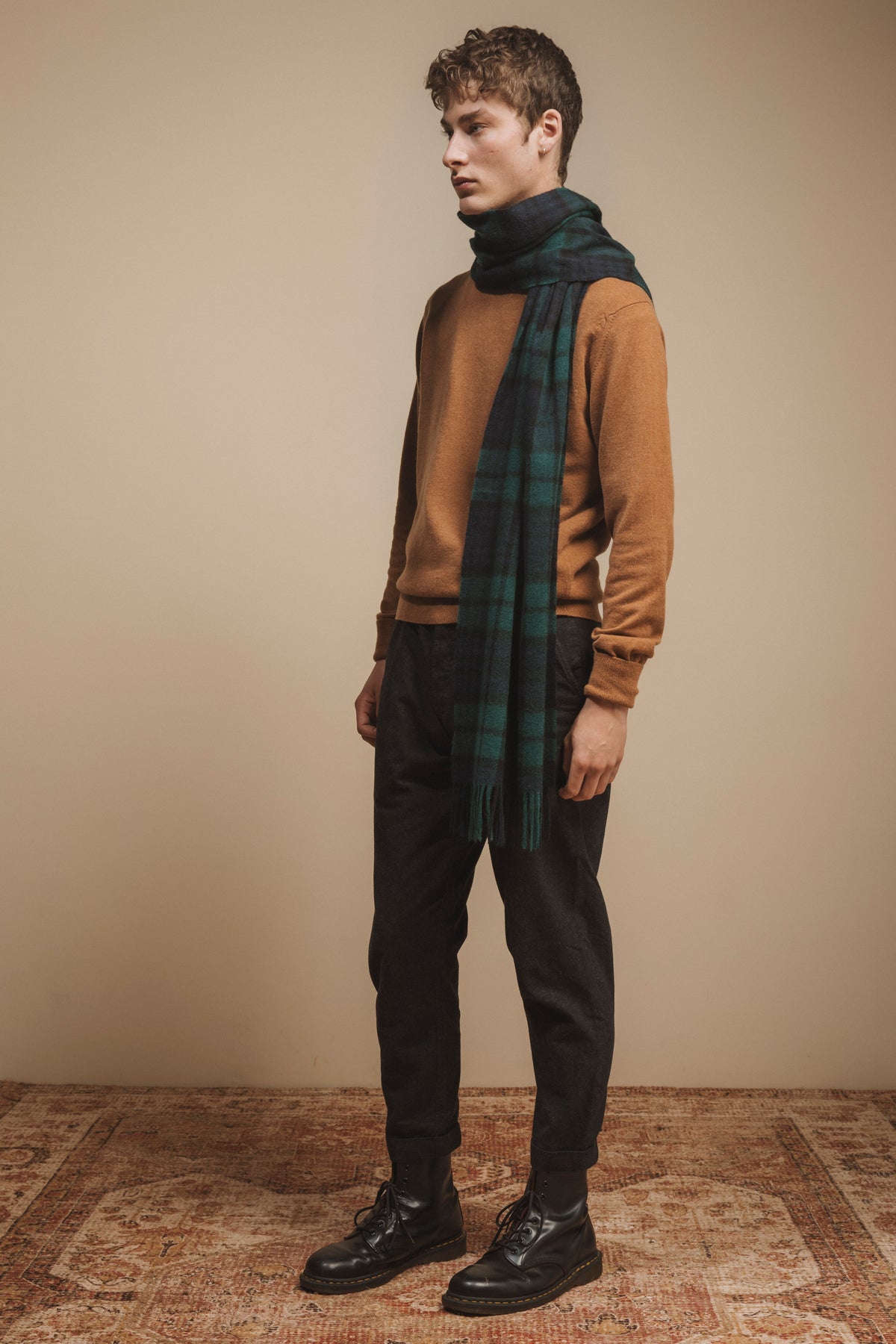 Made in Scotland Heritage Cashmere Wide Scarf in Blackwatch tartan, navy and green plaid with fringed ends, styled on a model