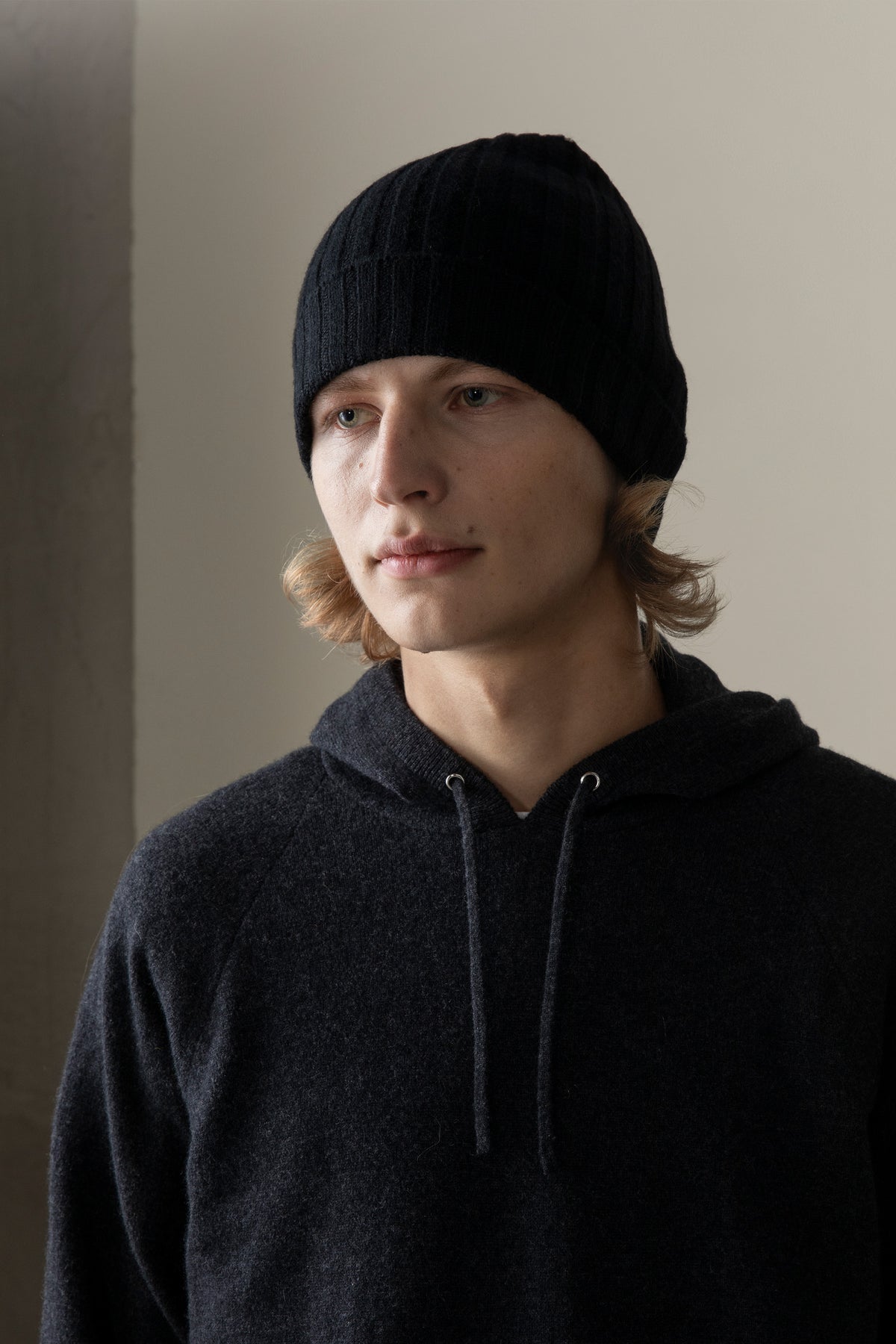 Model wearing the Unisex Cashmere Wide Ribbed Beanie Hat in black, front view showing the ribbed cuff and snug fit