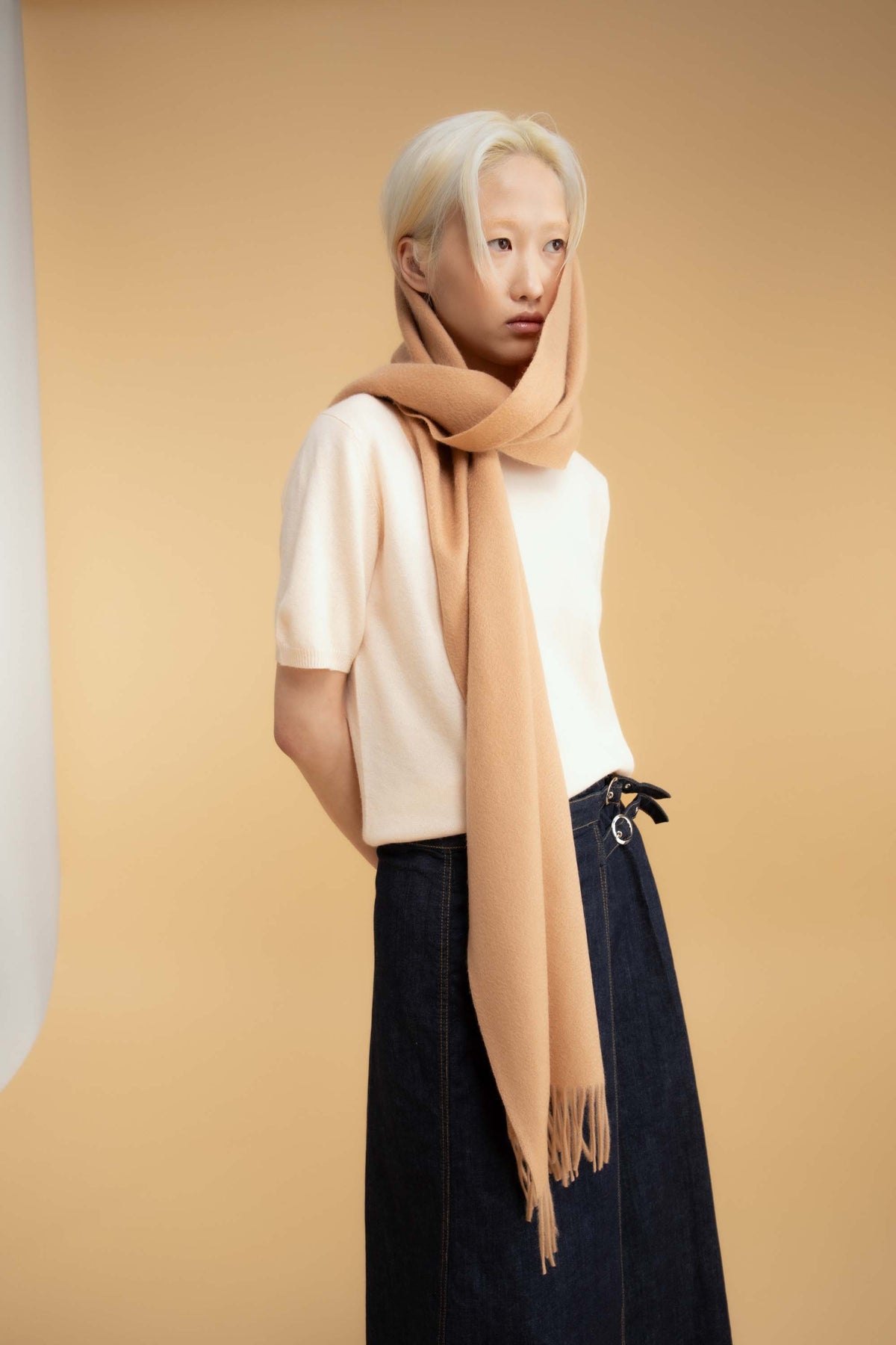 Solid Cashmere Wide Scarf in Warm Camel wrapped around the neck and head, showing drape and fringed ends