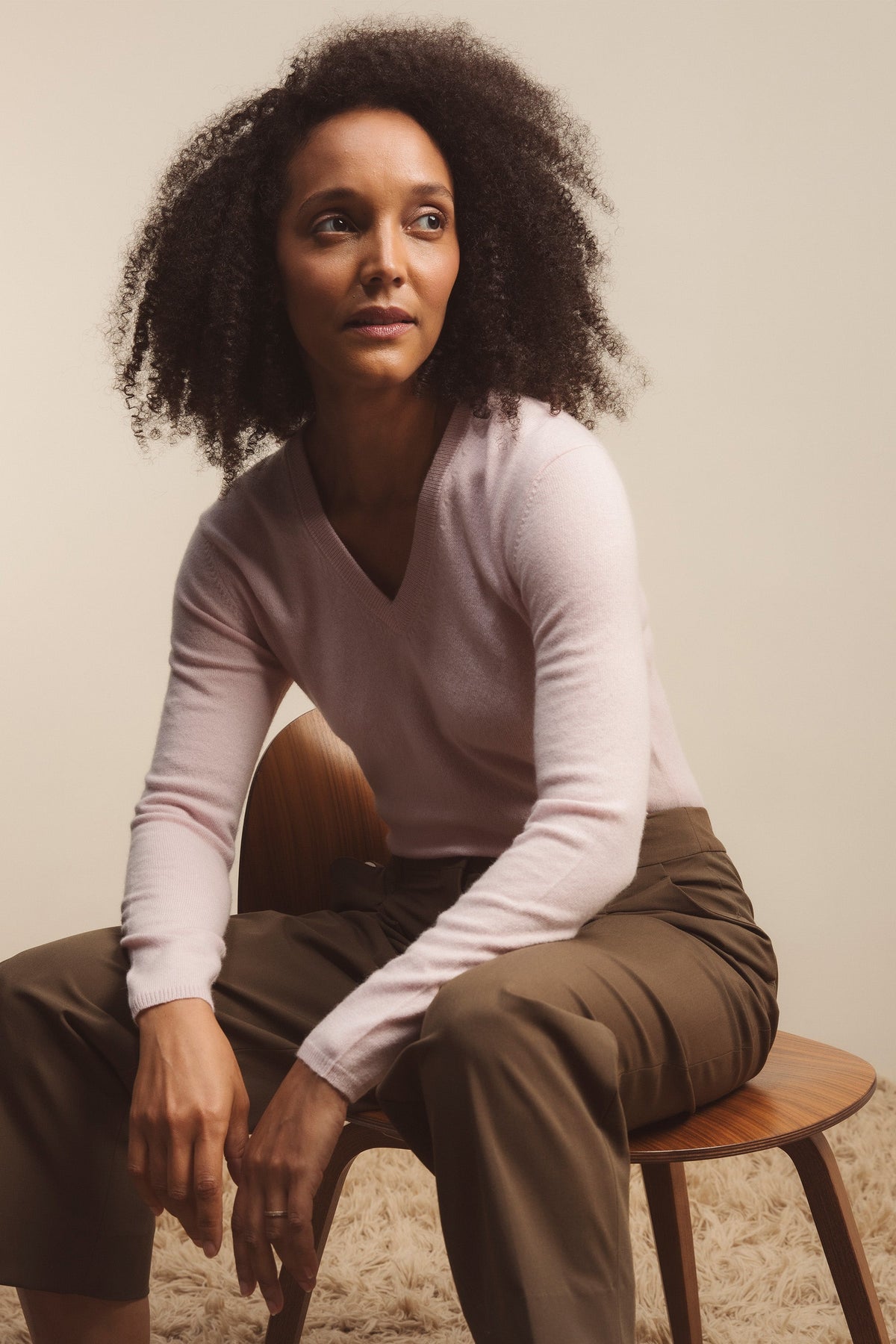Women's Cashmere V Neck Jumper in Pale Lilac, soft lightweight knit with ribbed cuffs, styled seated with olive trousers