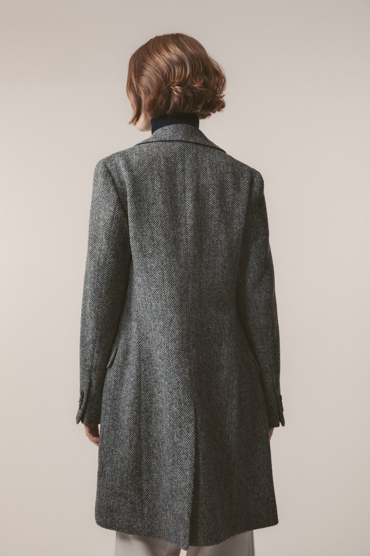 Back view of Women's Harris Tweed Melody Coat in light grey herringbone showing clean tailored lines and centre back seam