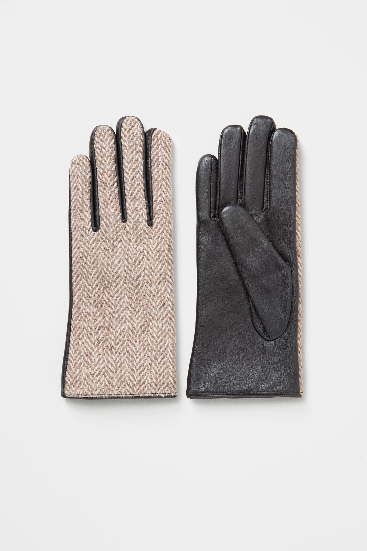 Women's Harris Tweed Gloves in light beige herringbone with black leather palms, shown front and back on a flat surface