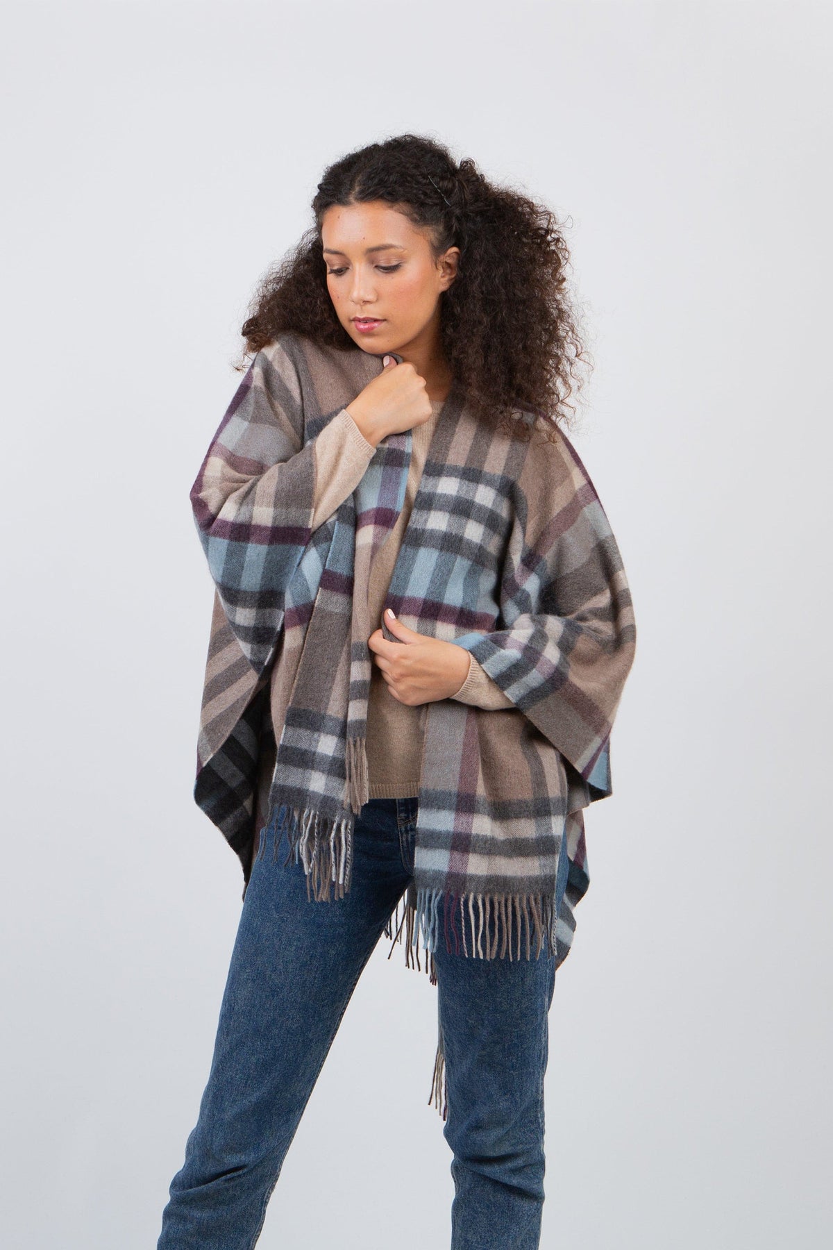 Tartan 2 Cashmere Wrap in Blue Taupe worn open-front over a sweater, showing blue and taupe plaid pattern with fringed hem