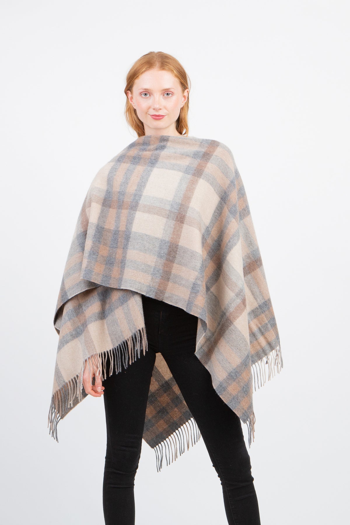 Tartan 2 Cashmere Wrap in Natural worn over shoulders, featuring beige, grey, and brown plaid pattern with fringed edges