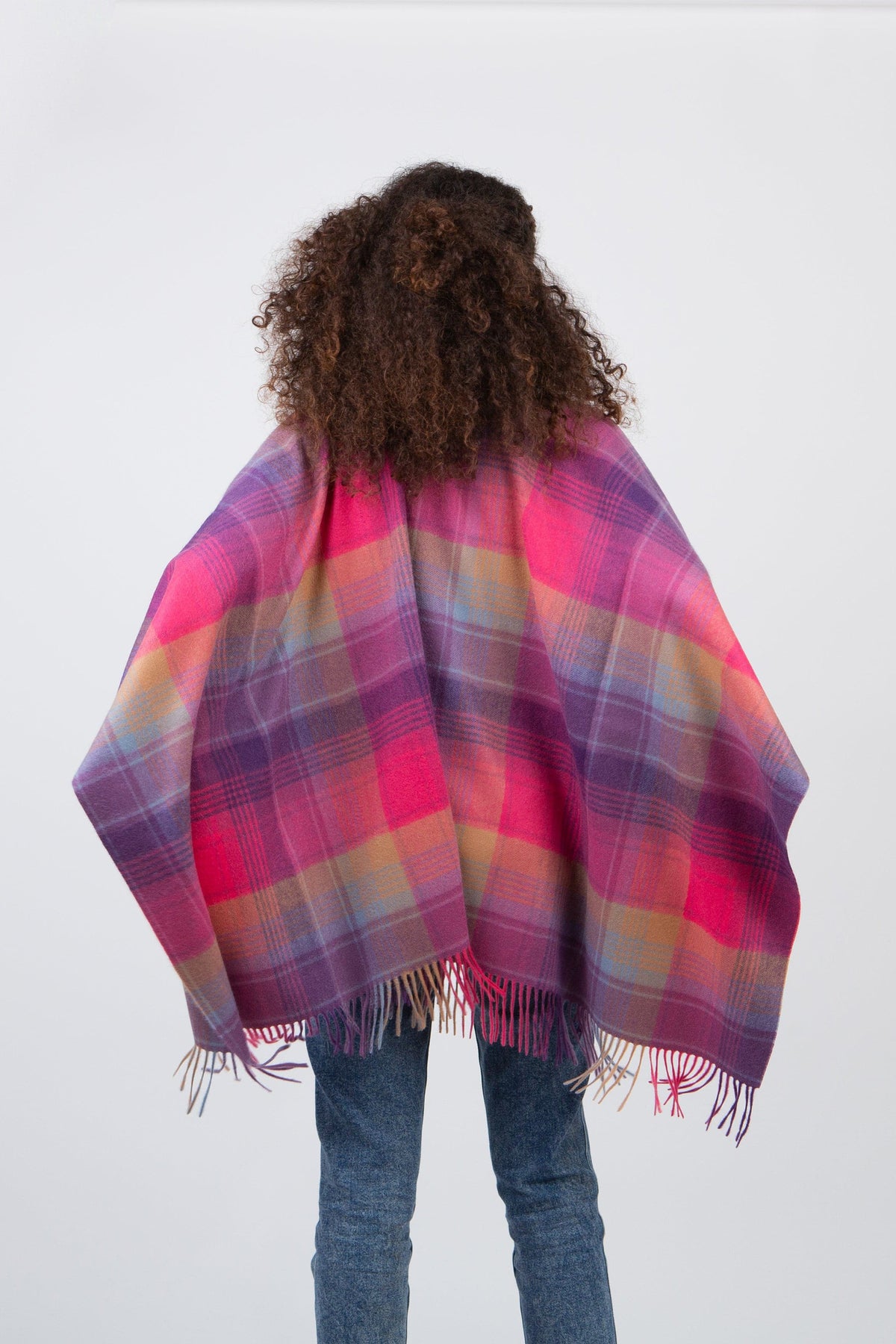 Back view of Repeat Edge Cashmere Wrap in Pink, showing full tartan plaid pattern in pink, purple, and gold with fringed hem