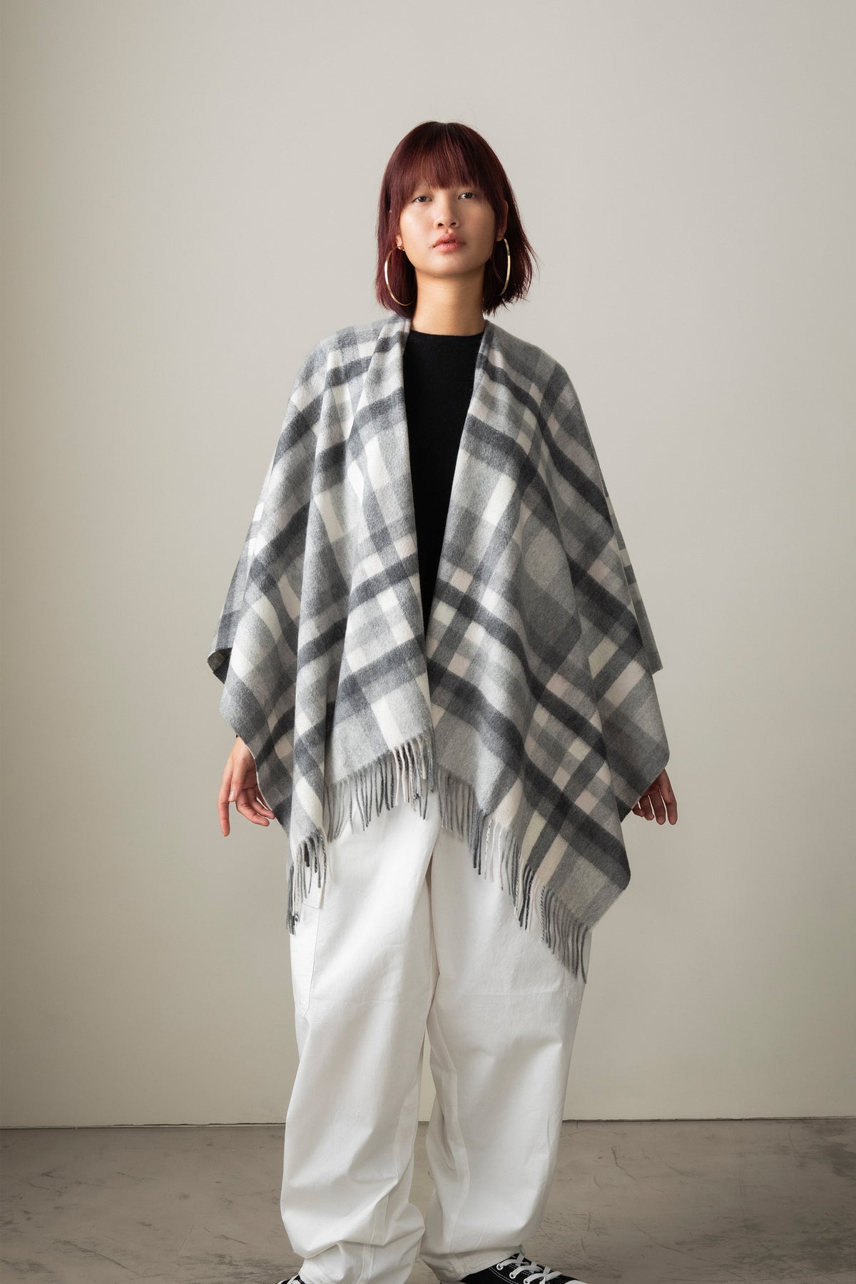 Stepping Check Cashmere Wrap in Monochrome, grey and white tartan plaid with fringed hem, draped open-front on model